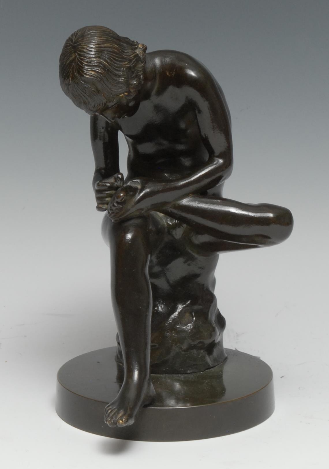 Italian Grand Tour School (19th century), a dark patinated library bronze, Spinario or Boy with Thorn, after the Antique Hellenistic, circular base, 19.5cm high