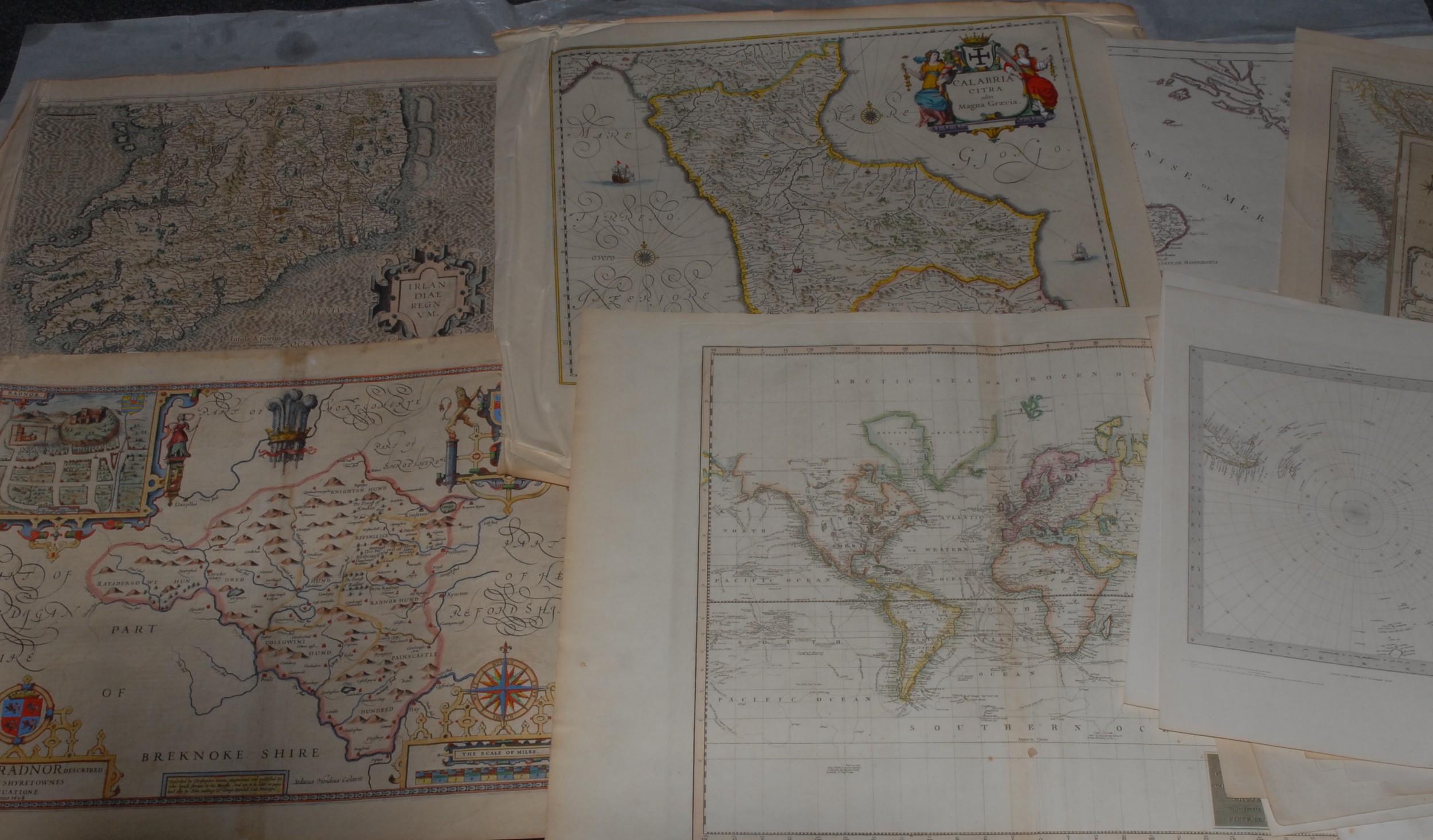 Cartography - a collection of 17th century and later maps of GB, Europe, and World, including Ireland, Gerardus Mercator (1512-1594), Irlandiae Regnum, [n.d., 1616], two-fold engraving, some colouring, 40.5cm x 52cm, (1); Christopher Saxton (c. 1540-c. 1610), Radnorshire, Wales, [London]: John Speed, [n.d.], copperplate engraving, later hand-colouring, 46cm x 52cm, (1); Emanuel Bowen (1694-1767), A New & Accurate Map of the Netherlands or Low Countries [...], No. 13, [London: 1747], two-fold, engraving, 46cm x 56.5cm, (1); Scott (R), Hydrographical Chart of the World on Wright or Mercator's Projection, [Edinburgh: 1814], two-fold hand-coloured engraving, 52cm x 71.5cm, (1); Polar, two maps: John & Charles Walker, Circumjacent of the North [&] South Pole, 19th century, 41cm x 33.5cm, (2); Robert de Vaugondy (1688-1766), [Northern Part] Royaume de Naples, Venice: 1779], copperplate engraving, delineated in colour, 51.5cm x 73cm, (1); Nicolas Bailleul le jeune (fl. 1740 - 1750), L'Italie [...], Lyon: 1762, two-fold engraving with some hand-colouring, 50cm x 70cm, (1); Pierre M. Lapie (19th century), Carte de l'Europe [&] Scandinavie, two-fold engravings, 67.5cm x 51.5cm & 51.5cm x 67.5cm, (2); Turkey, Syria, the Holy land, Italy; 17th century and later book leaves with in-text illustrations of globes, armillary spheres, cartographic and scientific instruments, (7); etc., [folio]