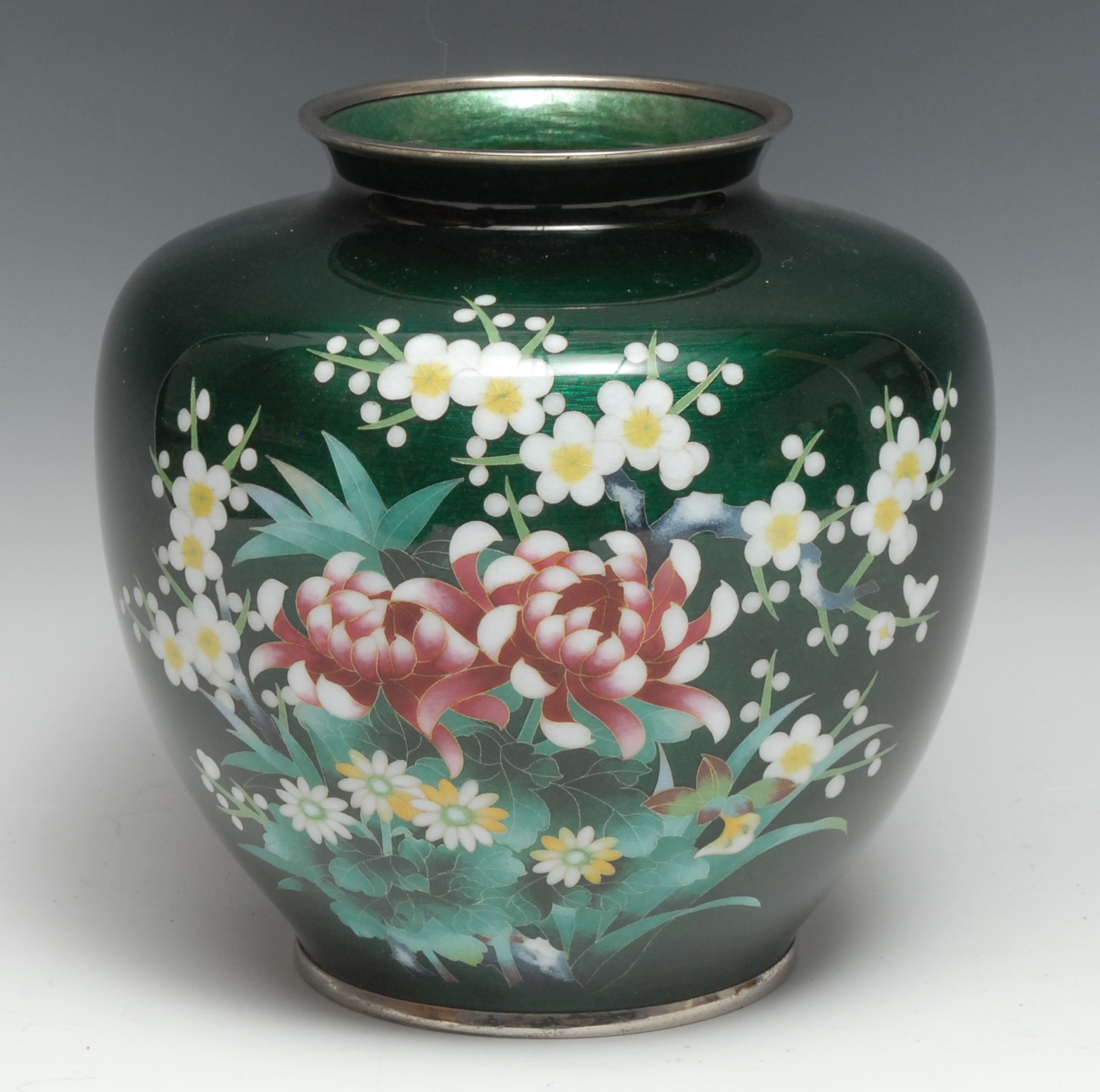 A Japanese cloisonne ovoid vase, decorated with chrysanthemums and blossoming prunus, on a green ground, 23cm high