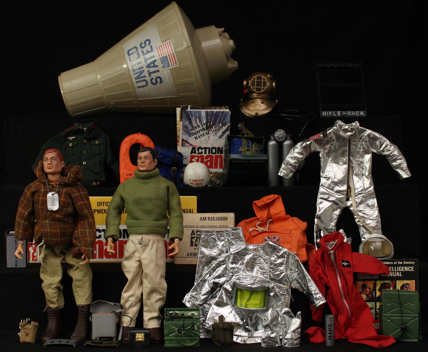 A 1960's Palitoy Action Man, hard plastic head with red hair and blue eyes, hard plastic hands, wearing a brown jacket, pale green trousers and brown plastic boots, early example with flesh painted rivets, marked 'MADE IN ENGLAND BY PALITOY UNDER LICENSE FROM HASBRO © 1964' to reverse torso, unboxed with Action Man metal dog tag; another Action Man with black hair and a large collection of Palitoy Action Man clothing, accessories, weapons and manuals, presented in a suitcase (quantity)