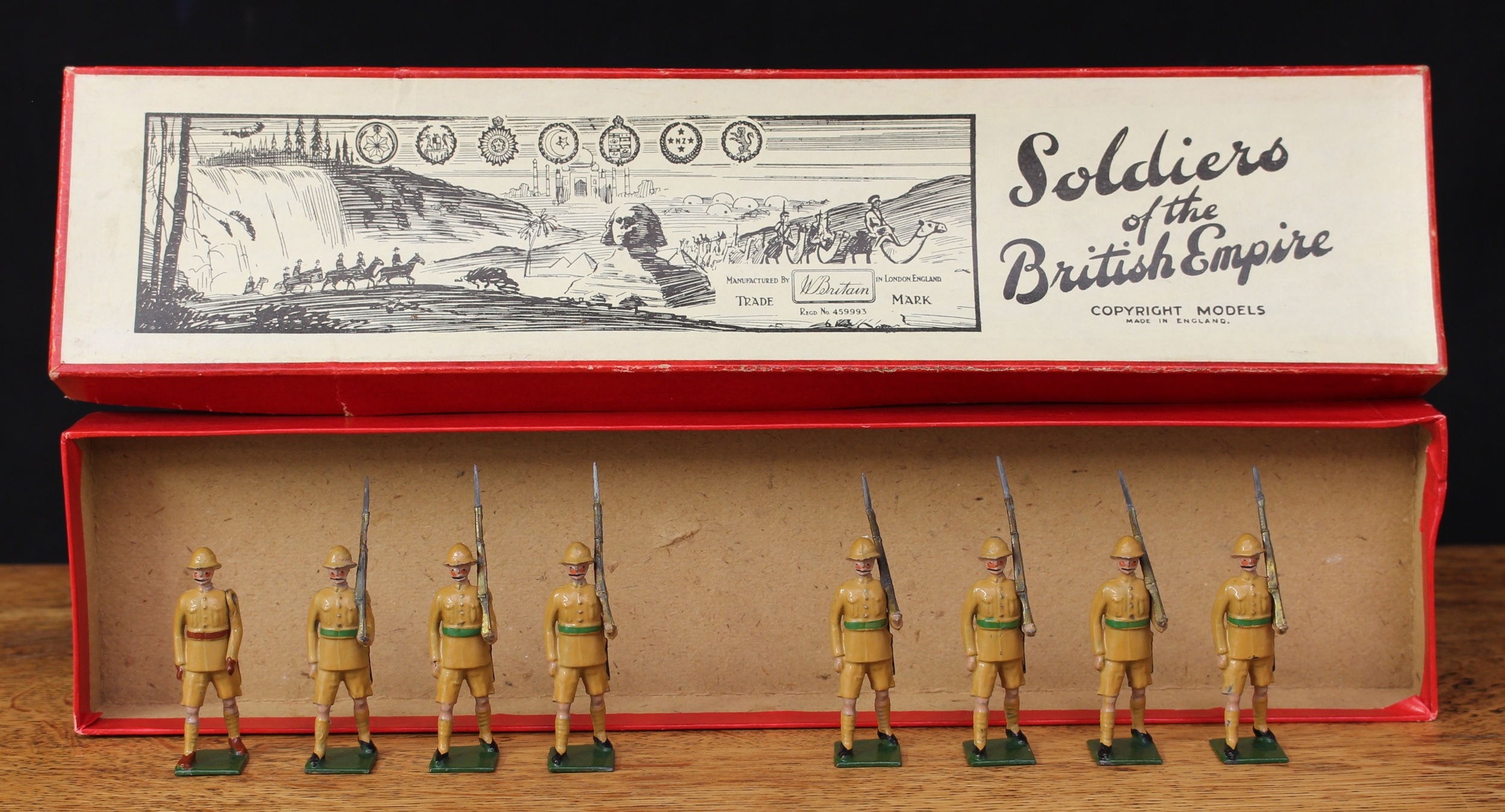 W Britain (Britains) Famous Regiments of the British Army No.1599 Royal Northumberland Fusiliers, comprising marching empty handed officer and seven figures, each marching at the slope, boxed with original inner cardboard display piece - green label to box lid