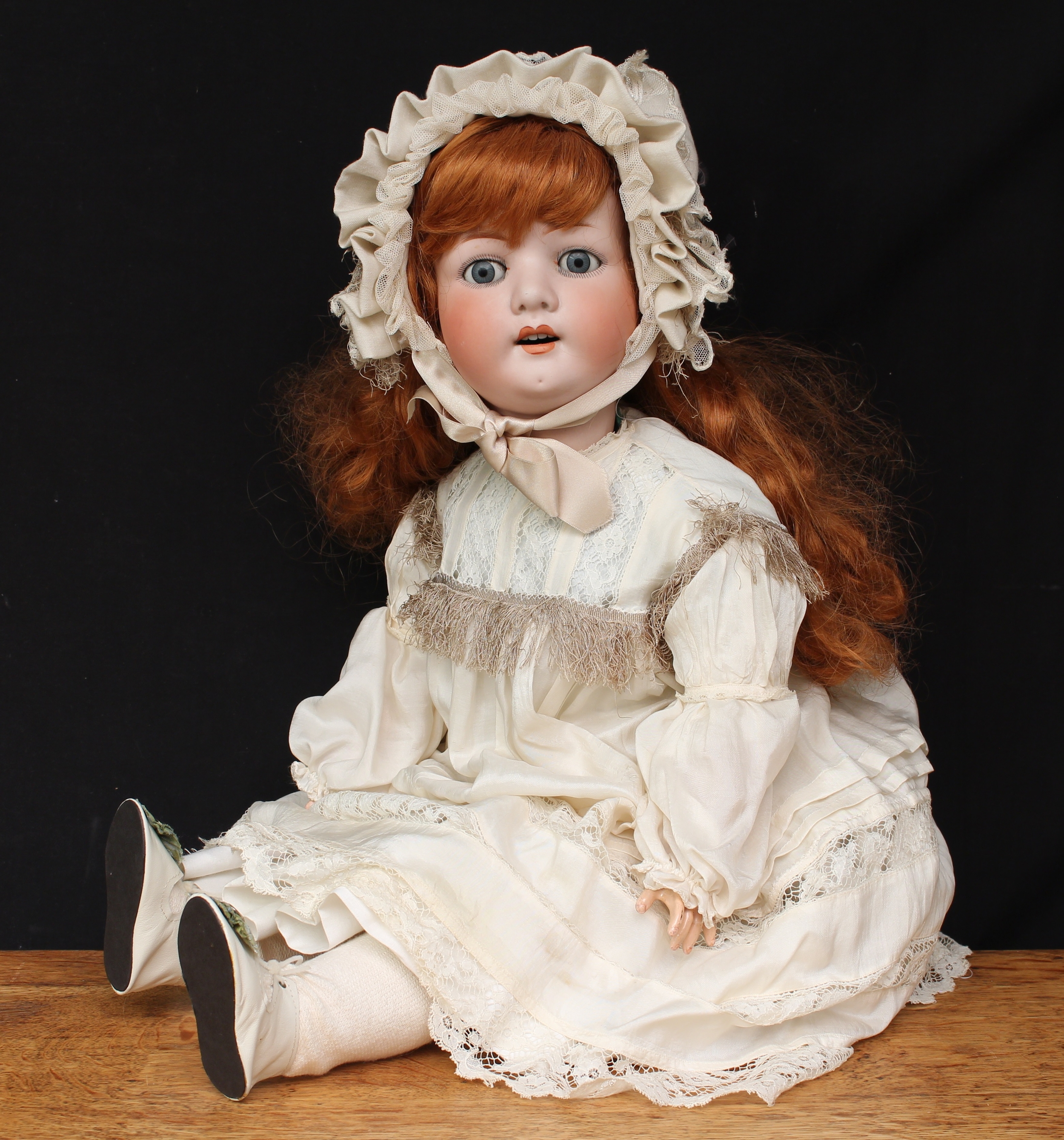 A large Heubach Koppelsdorf (Germany) bisque head and ball jointed painted composition bodied doll, sleeping blue glass eyes, painted features including fine eyelashes and brown feathered eyebrows, open mouth revealing teeth, red wig, impressed marks 'HEUBACH. 302.9. KOPPELSDORF. GERMANY.', 76cm high