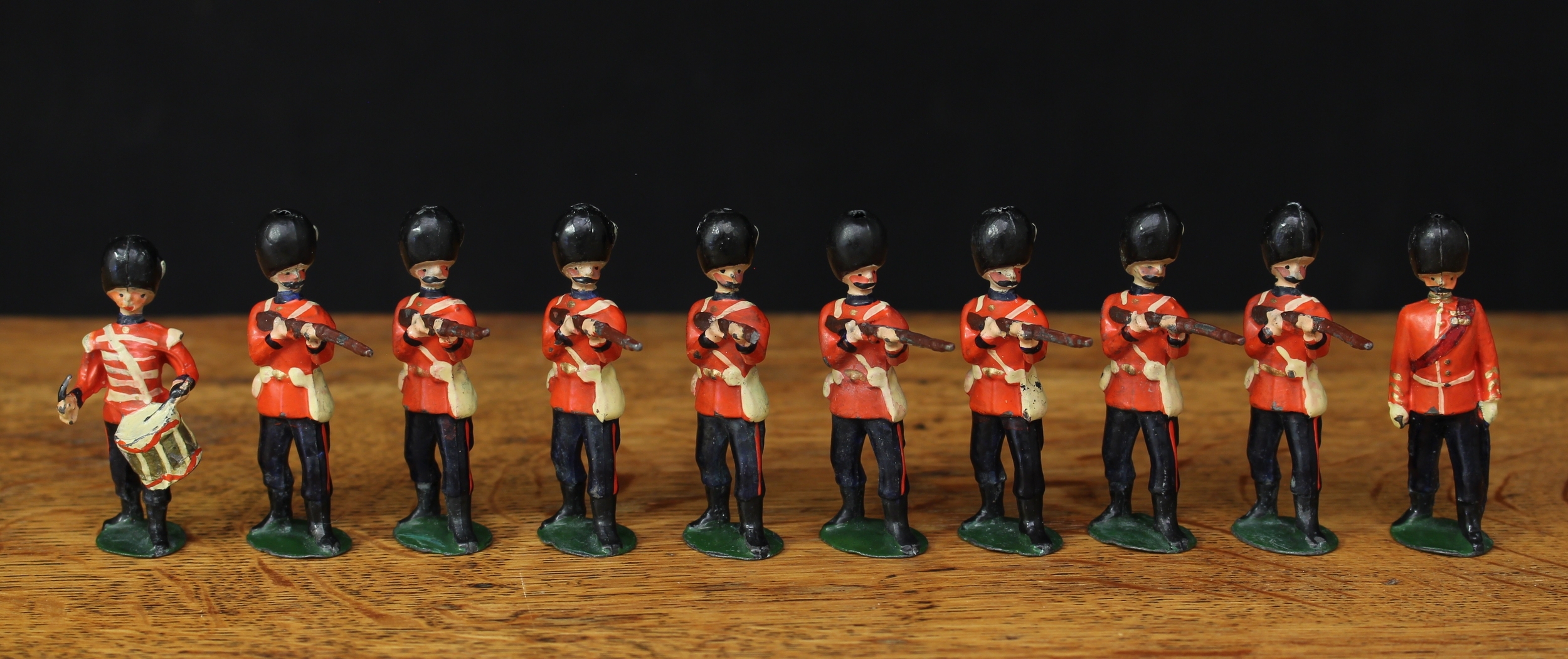 W Britain (Britains) No.34 The Grenadier Guards, comprising fixed arm marching officer, marching side drummer and eight figures, each volley firing, oval bases, unboxed (10)