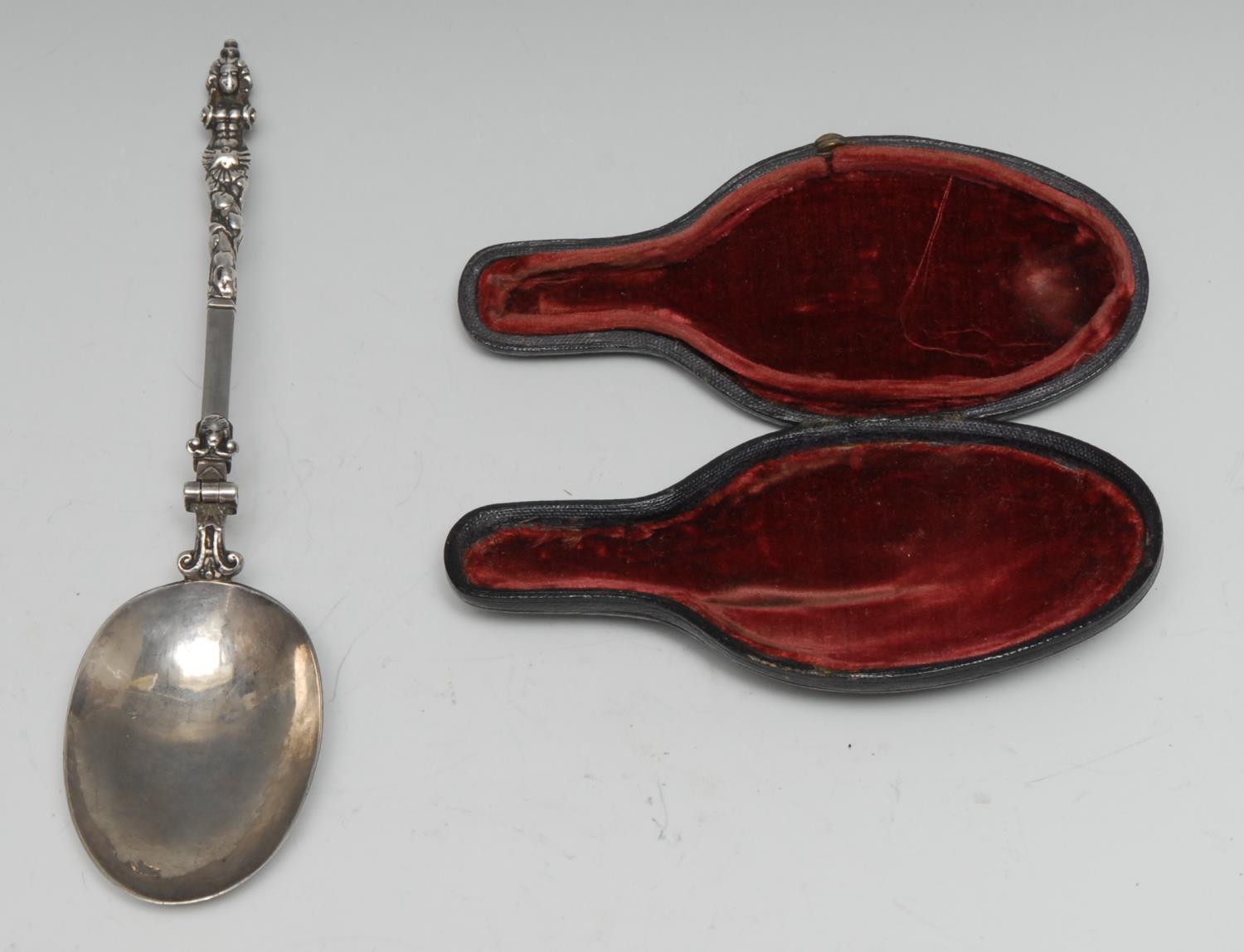 An 18th century Continental silver folding travelling spoon, cast herm finial, hatched ownership initials MH, 16cm long, cased