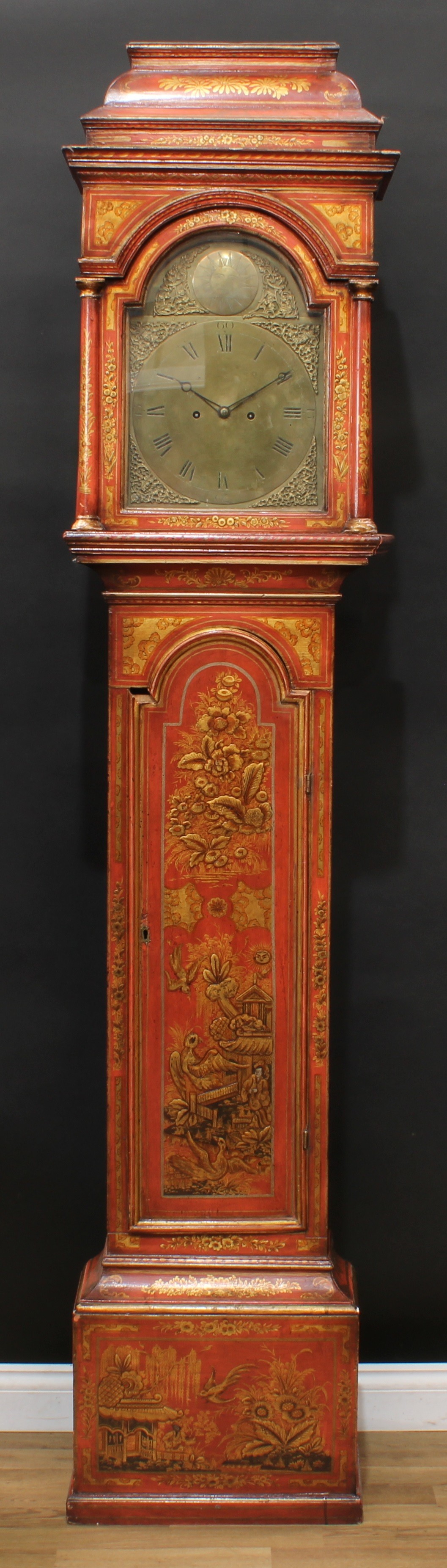 A George II Japanned longcase clock, 31cm arched brass dial inscribed with Roman numerals, sun-in-splendour to arch, twin winding holes, eight day movement striking on a bell, the pagoda top case decorated after Chinese lacquer on a red ground, 235cm high