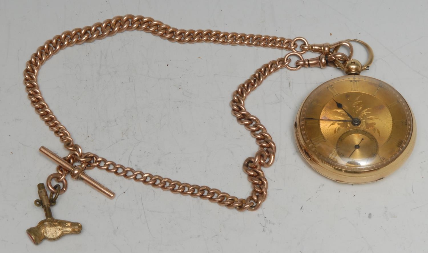 An 18ct gold open face pocket watch, Roman numerals, subsidiary seconds dial, Chester 1860, an equine gilt brass horse mask winding key; with a 9ct rose gold Albert chain, 47.6g