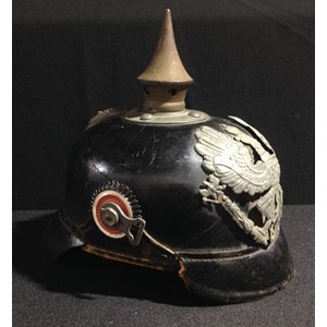 WW1 Imperial German Army Pickelhaube Helmet M1915. Complete with chinstrap fittings, but leather chinstrap is missing. Prussian helmet plate in wartime grey finish. Spike unscrews. Size marked "57". Maker marked "Gammersbach, Rolsdorf" and dated 1917. Nine finger leather liner present.