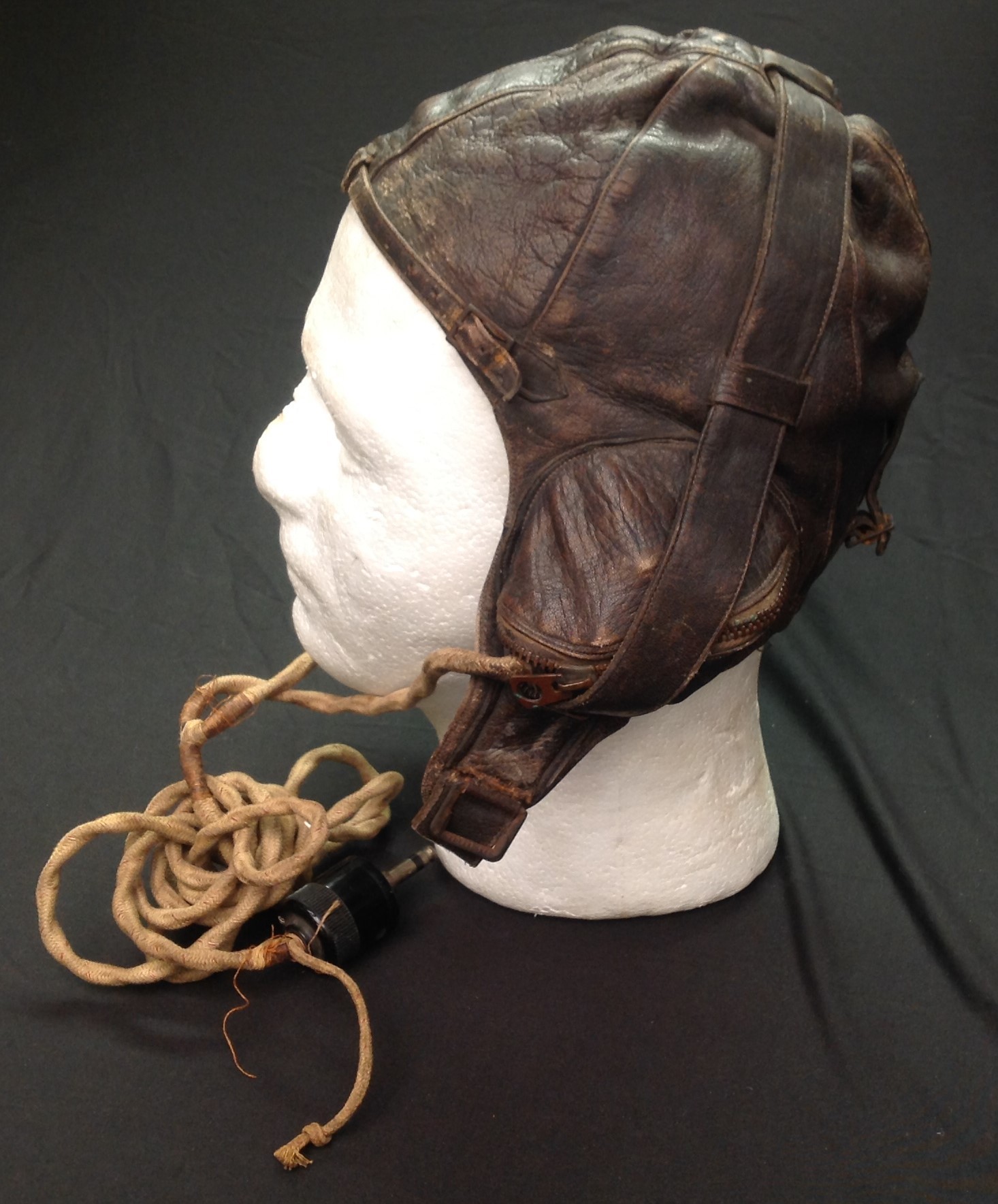 WW2 RAAF Australian Pattern Leather Flying Helmet. Similar to the RAF B type. Makers label "Lasicas, Australia". Chin strap has been cut off. Complete with headsets and wiring loom with jack plug.
