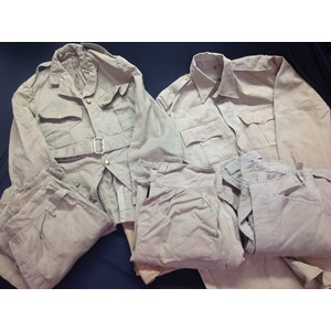 WW2 British Scots Guards Officers Khaki Drill Uniform group comprising of: Officers KD Scottish pattern cut away jacket, some buttons missing, no rank pips, complete with belt, approx 34 chest: KD Shirt: KD Breeches: KD Trousers: KD Shorts. No dates or makers markings to any of the uniform. (5)