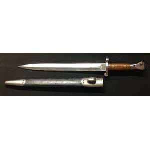 British 1888 pattern Lee Metford bayonet. Double edged blade 302mm in length, maker marked "Wilkinson, London" and dated 5 / 00 along with Crown and VR and inspection stamps. Overall length 425mm. Working release catch. Complete with scabbard which is well marked with inspection stamps.