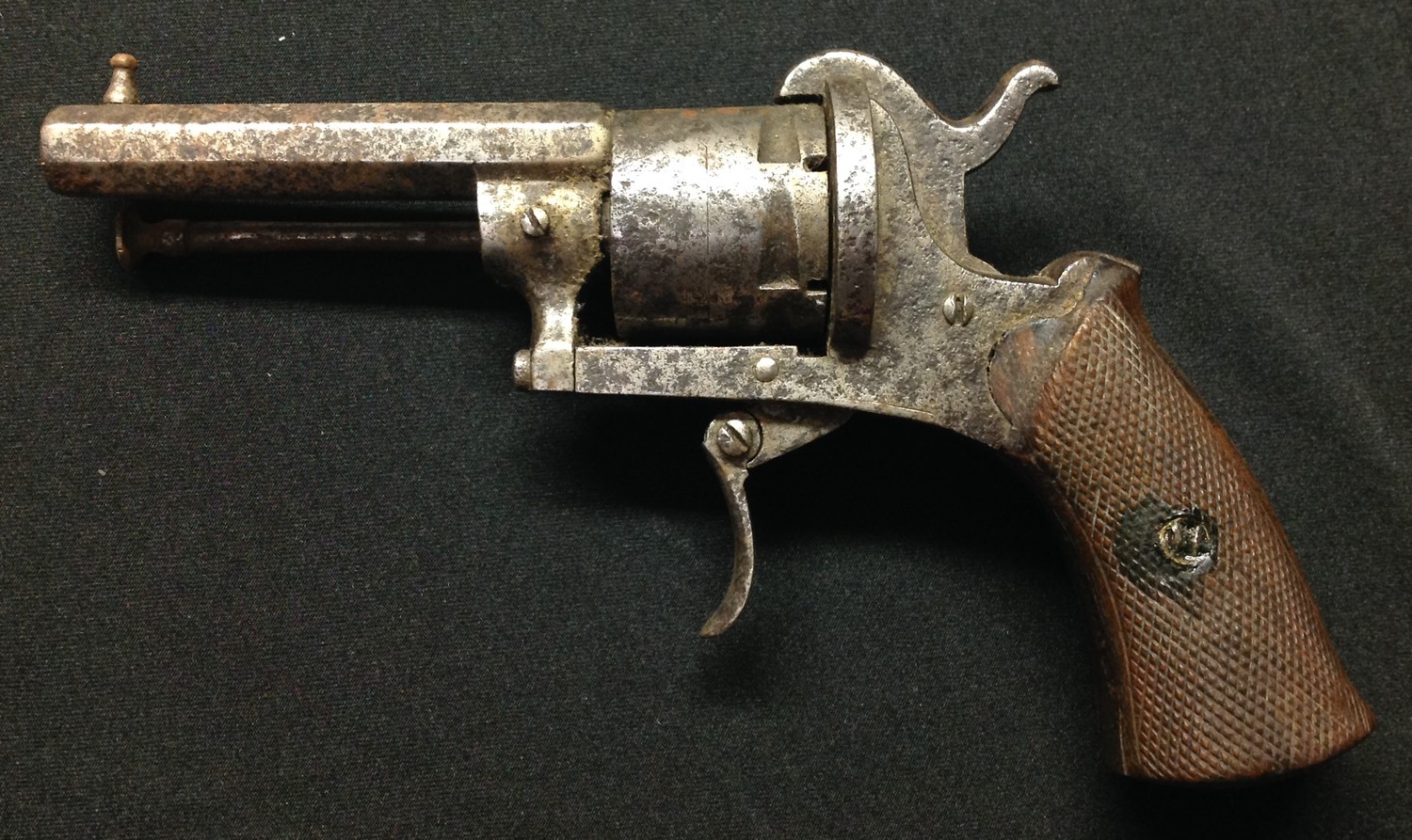 Belgian made Pinfire Revolver with 73mm long octagonal barrel. Bore approx 7mm. Cylinder marked "The Guardian American Model 1878" along with Leige proof marks. Single action. Chequered wooden grips. Frame, folding trigger and cylinder numbered 58. Working clearing rod. Overall length 175mm. Section 58, no licence required.