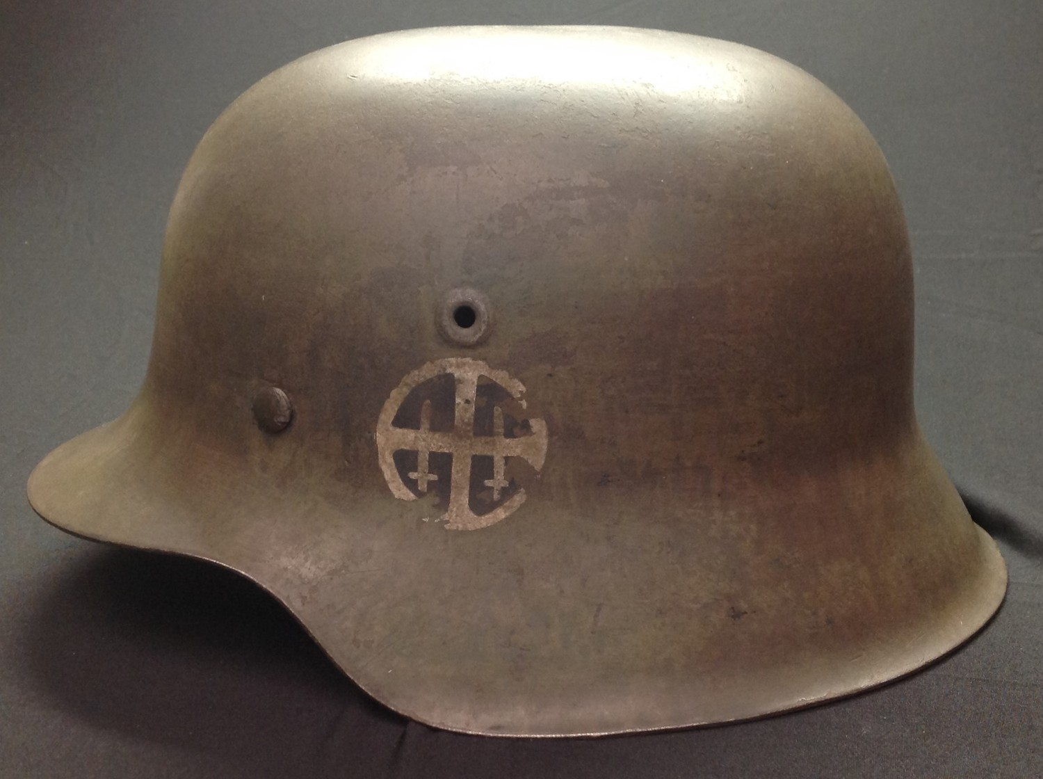 WW2 Third Reich M42 Stahlhelm Steel Helmet. Has been reused as a film prop or for re-enactment. Non original paintwork for the Norwegian Nasjonal Samling. Liner replaced with a 1939 dated size 7 British liner. Helmet shell has lot number 3792.