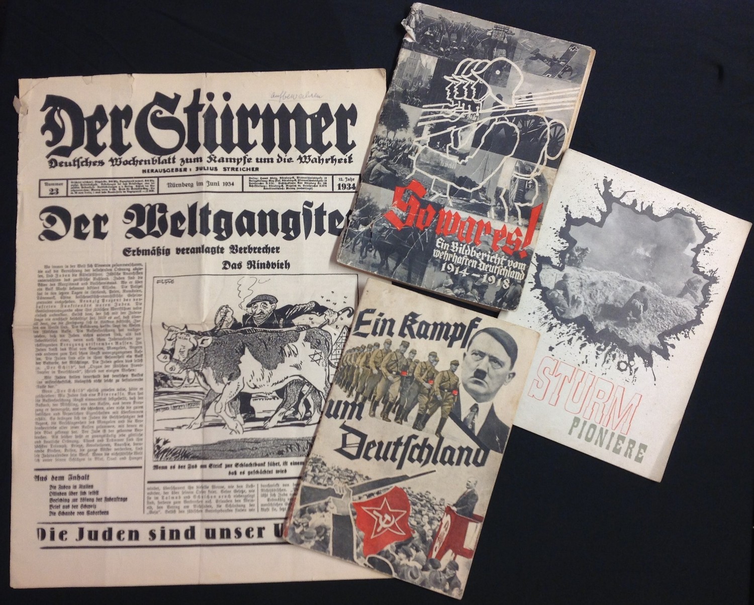 WW2 Third Reich paperwork collection to include four items: A rare copy of "Der Sturmer" newspaper nummer 23 Juni 1934: Magazine "Ein Kampf um Deutschland 1933": Magazine "Sturm Pioneer" Februar 1943: Illustrated WW1 photographic magazine "Vorwarts, Ein Bilderbuch von Wehrhaften Deutschland 1914 -18". (4)