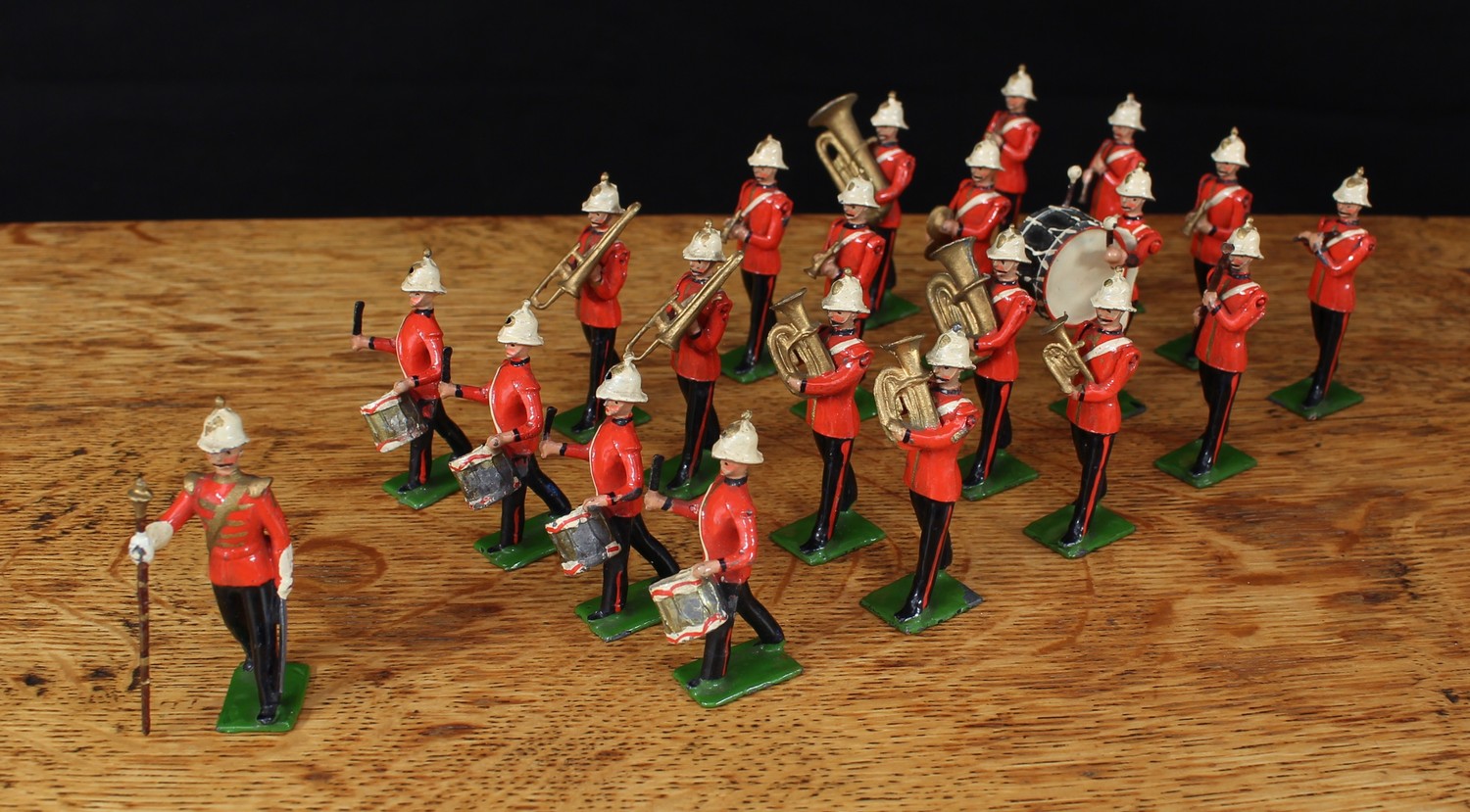 A rare W Britain (Britains) group of twenty one figures from No.1622 Royal Marine Light Infantry Band, each in red tunics with blue collars and cuffs, white helmets, comprising Bandmaster with baton, one cymbalist, four side drummers, one bass drummer, two trombonists, two double bass horn players, three euphonium players, three trumpeters, two clarinettists, fife player and bassoon player, each with rectangular bases, each unboxed (21)