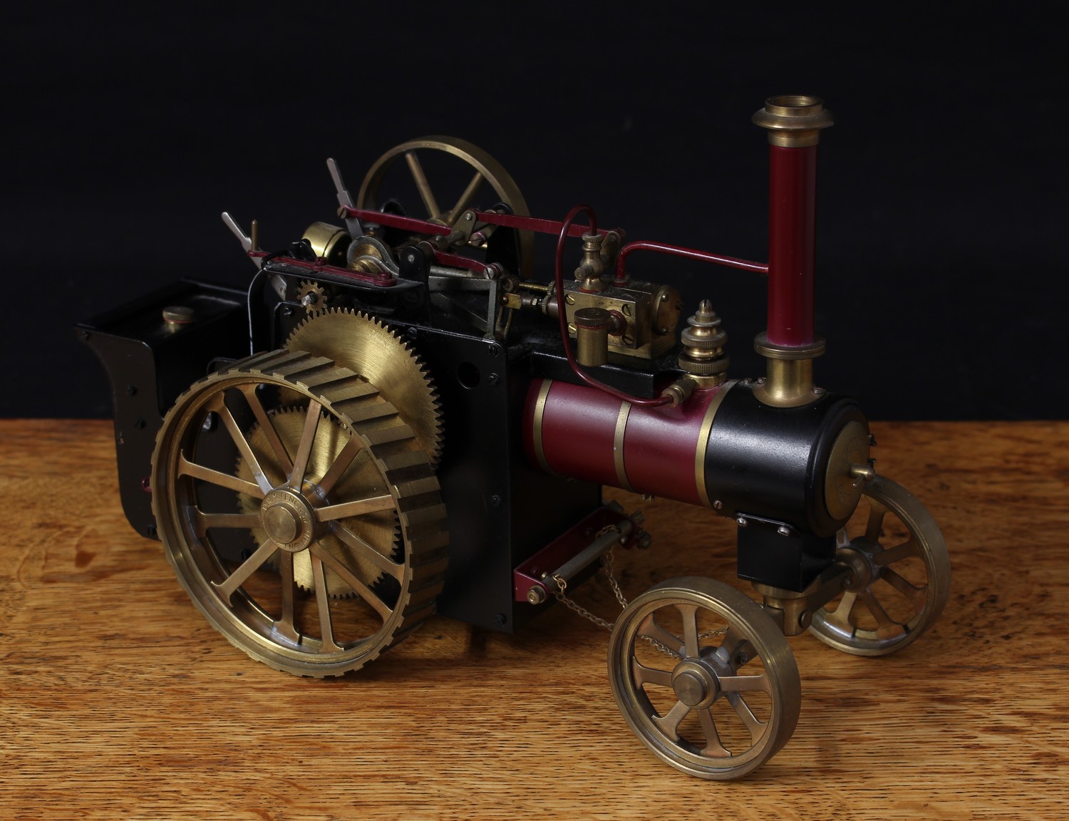 D.R. Mercer (Precision Engineers, Birmingham) type two kit built and painted live steam traction engine, approximately 5/8th to 1 inch scale, maroon livery, fitted with English style brass straked wheels, large six spoke flywheel, singled flange chimney and pressure gauge fitted as standard, 31cm long