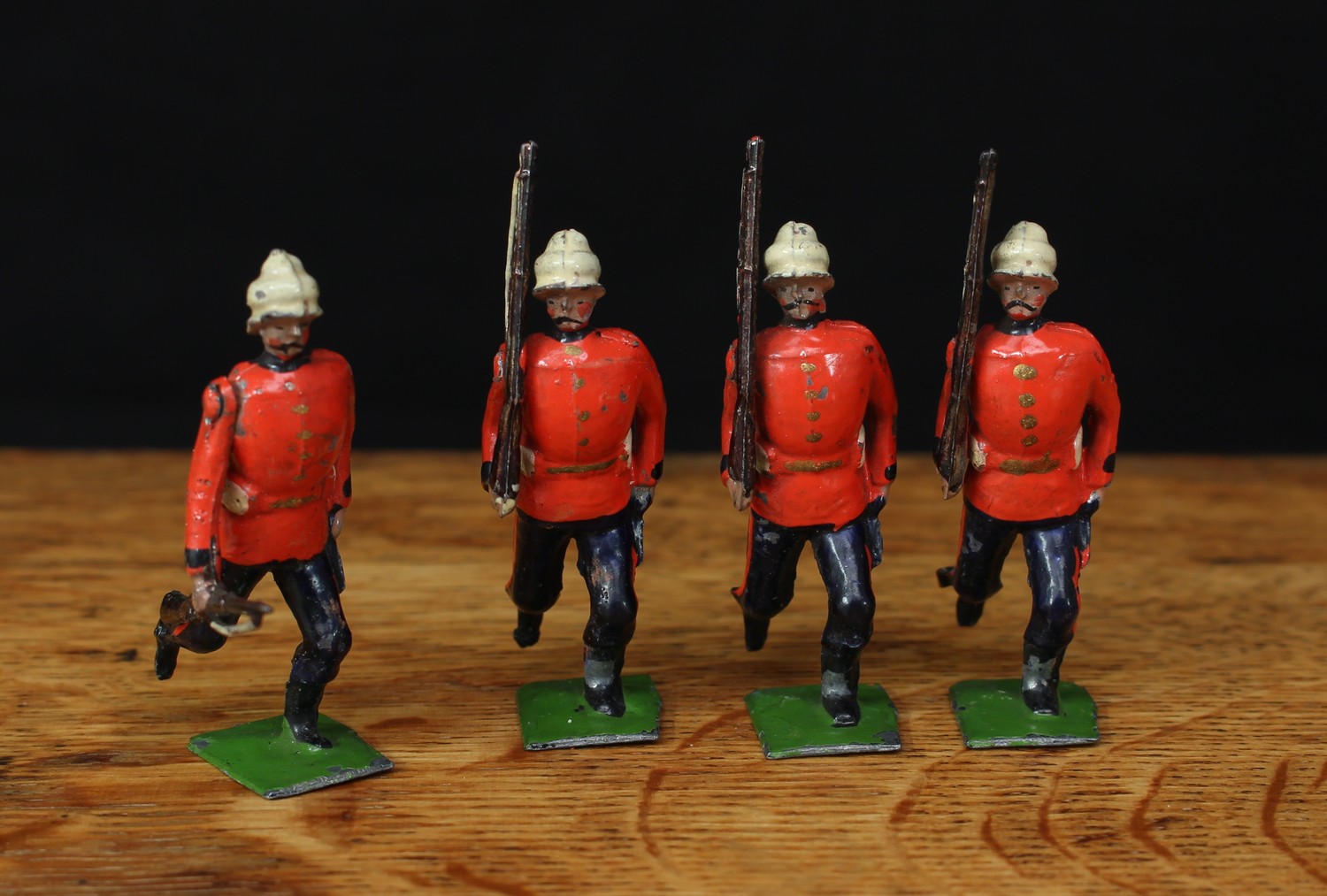 W Britain (Britains) No.148 Royal Lancaster Regiment, comprising four infantrymen, each running at the trail, movable arms, rectangular bases, unboxed (4)
