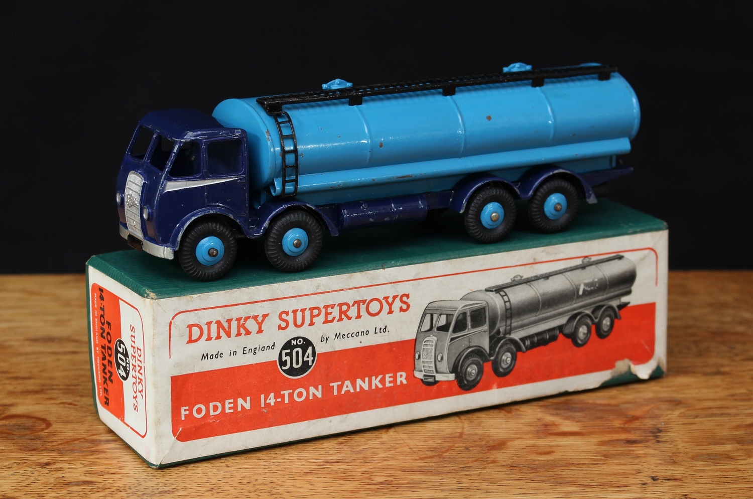 Dinky Supertoys 504 Foden 14-ton Tanker, dark blue cab and chassis with Foden 'DG' (1st type) exposed radiator and silver flashes to sides, pale blue tanker, pale blue ridged hubs, boxed - green box with printed illustrated paper label to box lid
