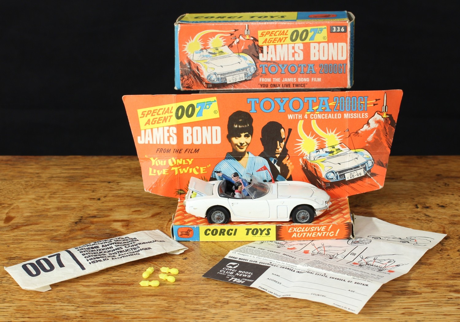 Corgi Toys 336 Special Agent 007 James Bond Toyota 2000GT from the James Bond Film "You Only Live Twice", white body with red plastic flag intact, two seated plastic figures to black interior, spoke wire hubs, boxed with original inner pictorial display stand, original 'secret instructions' in packet and eight loose yellow concealed missiles