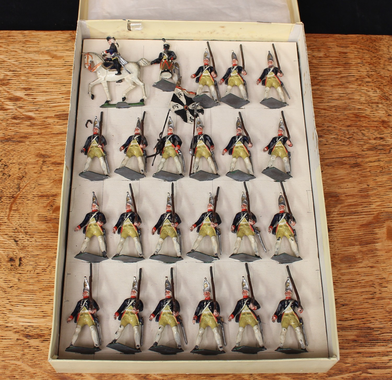 An unusual Continental set of twenty-three painted lead figures of Prussian Frederick 'the great' 15th grenadier guards regiment, various poses including an officer mounted on horseback, displayed in a later box, probably manufactured by Lucotte/Mignot or similar (23)