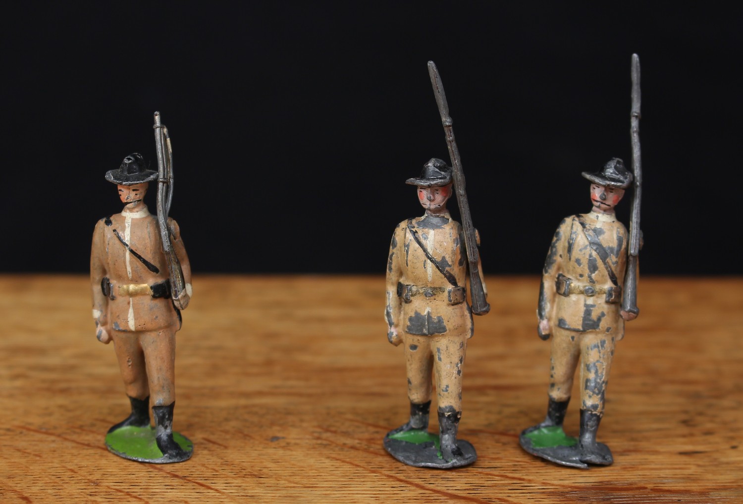 W Britain (Britains) No.26 Boer Infantry, comprising two figures, marching at the slope with bayonets, movable arms and unmarked oval bases; another similar figure, all unboxed (3)