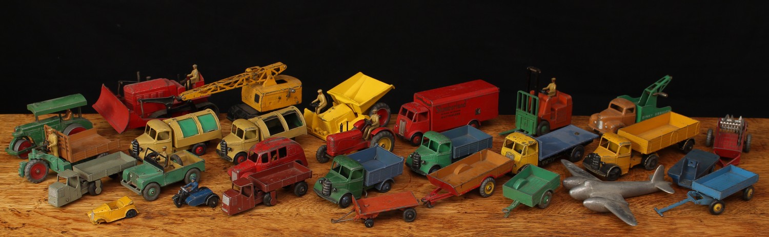 A collection of unboxed playworn diecast Dinky Toys and Dinky Supertoys, including 300 Massey Harris tractor, red body with painted driver figure, yellow centre to wheels; 410 Bedford end tipper, green cab and chassis with blue wagon, blue ridged hubs; 514 Guy van 'Slumberland', red body with decals to sides, red ridged hubs; others, all unboxed (28)