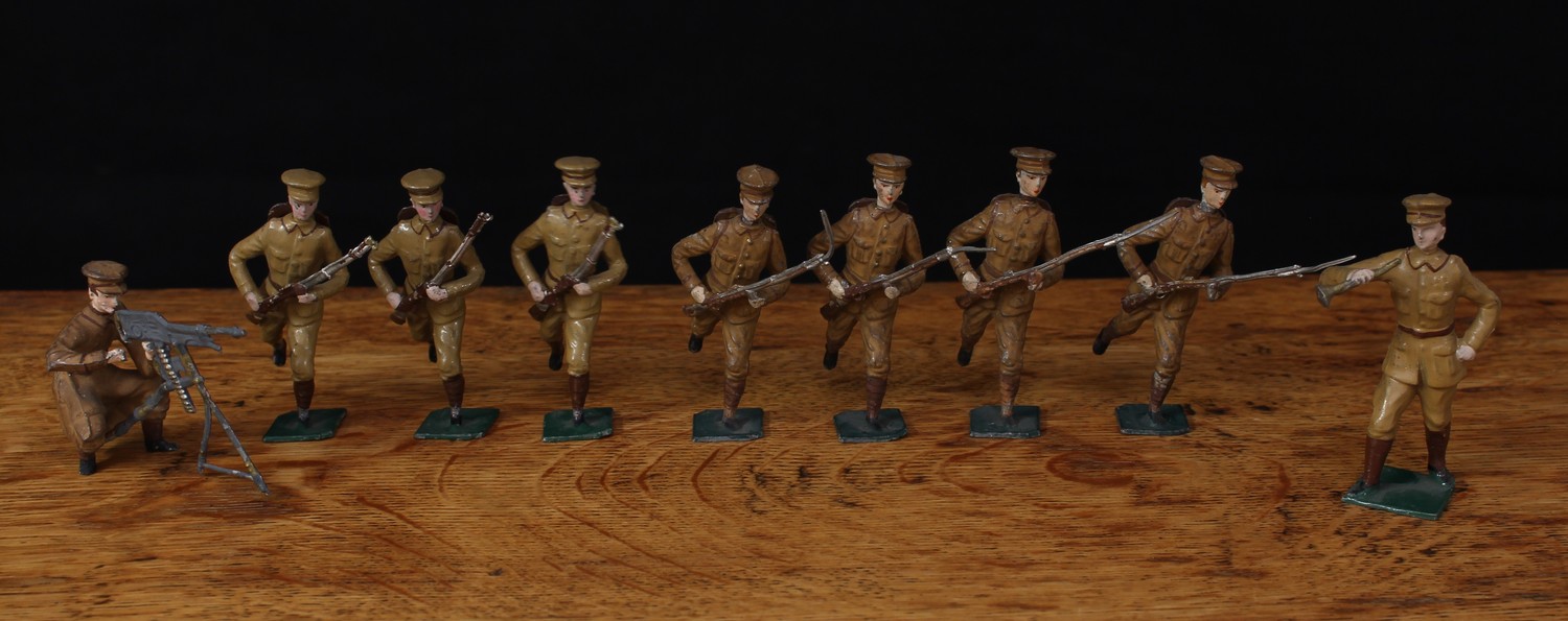 A group of French manufactured oversized lead figures as British soldiers, various poses, each in tan uniform with peaked caps, one figure marked to the underside of base 'XR PARIS', unboxed (9)