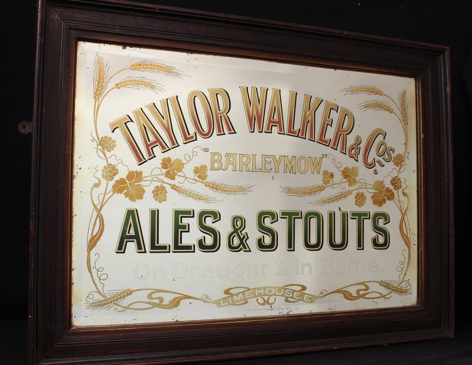 Advertising, Breweriana - a large late 19th century/early 20th century Taylor Walker & Co rectangular bevelled edged pub/brewery advertising mirror, "TAYLOR WALKER & COs BARLEYMOW ALES & STOUTS ON DRAUGHT & IN BOTTLES, LIMEHOUSE", gold and coloured lettering, flanked by a side and lower edged border made up of hops and barley, SIR J CAUSTON & SONS LTD MAKERS LONDON, framed, 71cm x 96cm (measurements including frame)