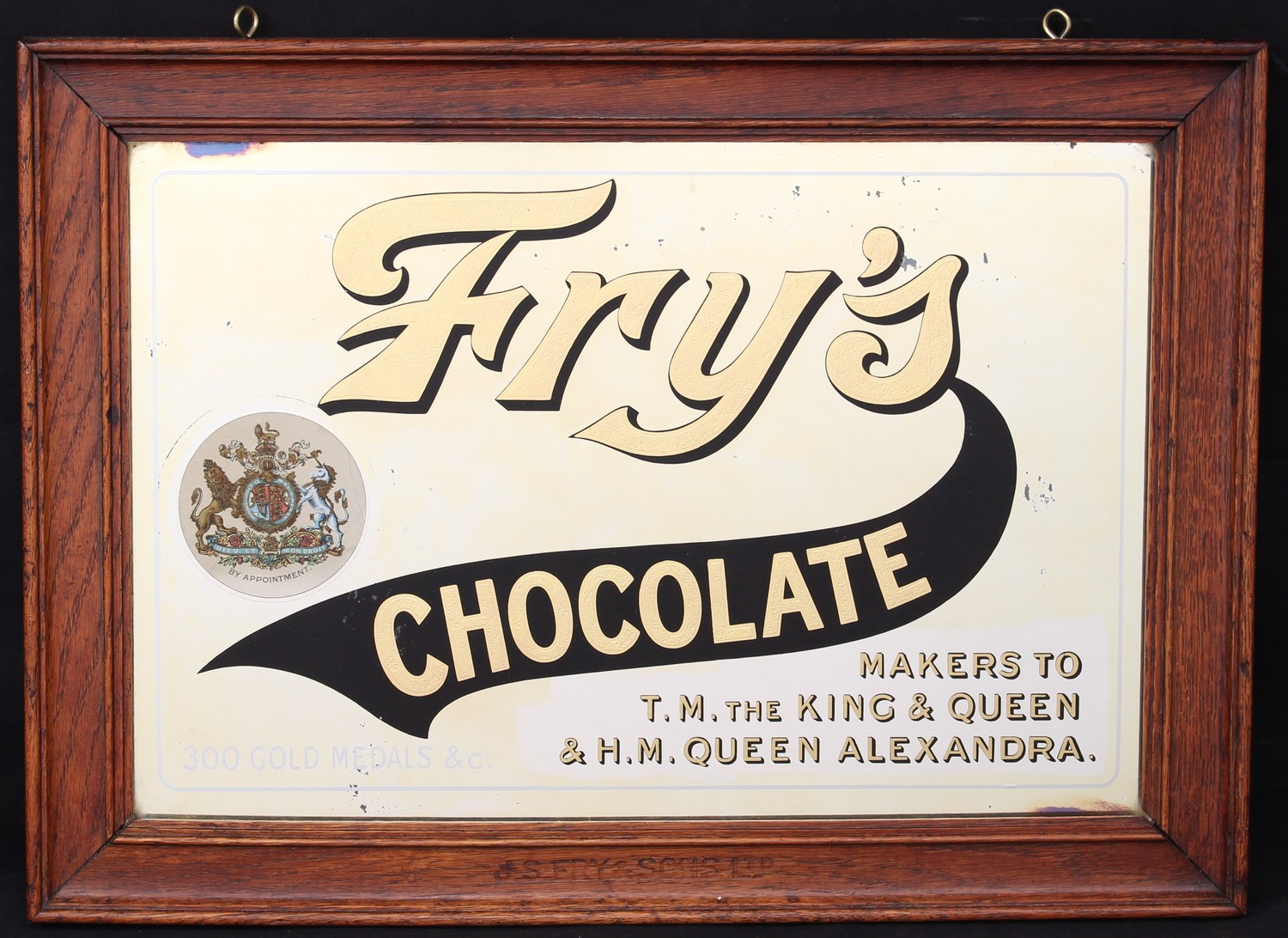 Advertising, Confectionery and Chocolate - an early 20th century Fry's rectangular point of sale advertising mirror, "Fry's CHOCOLATE, 300 GOLD MEDALS & c., MAKERS TO T.M. THE KING & QUEEN & H.M. QUEEN ALEXANDRA", gold and black lettering, oak frame stamped 'J.S.FRY & SONS LTD', 39cm x 54cm (measurements including frame)