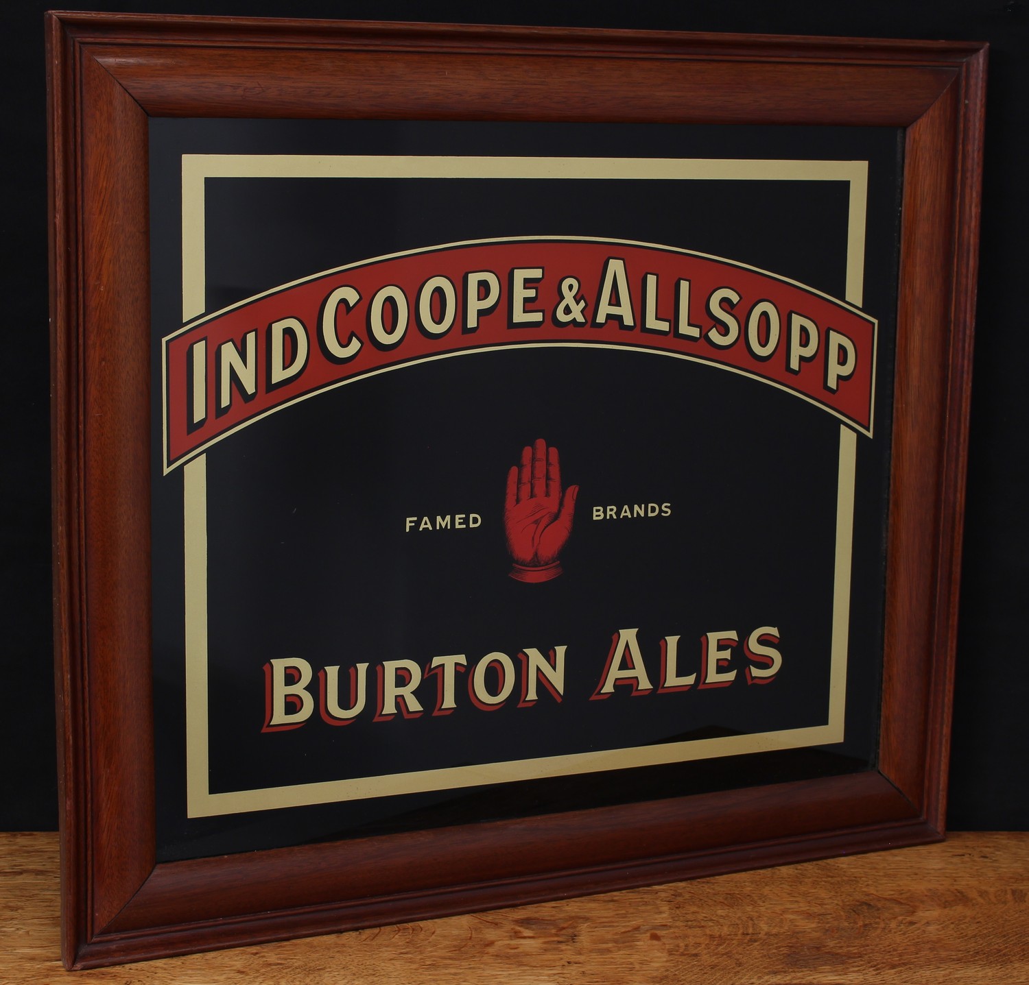 Advertising, Breweriana - Ind Coope & Allsopp rectangular reverse painted glass pub/brewery advertising sign, "IND COOPE & ALLSOPP, FAMED BRANDS, BURTON ALES", red and gold lettering on a black ground, framed with stamped mark to backing board 'THIS IS PROPERTY OF IND COOPE & ALLSOPP LTD', 57cm x 64cm (measurements including frame)