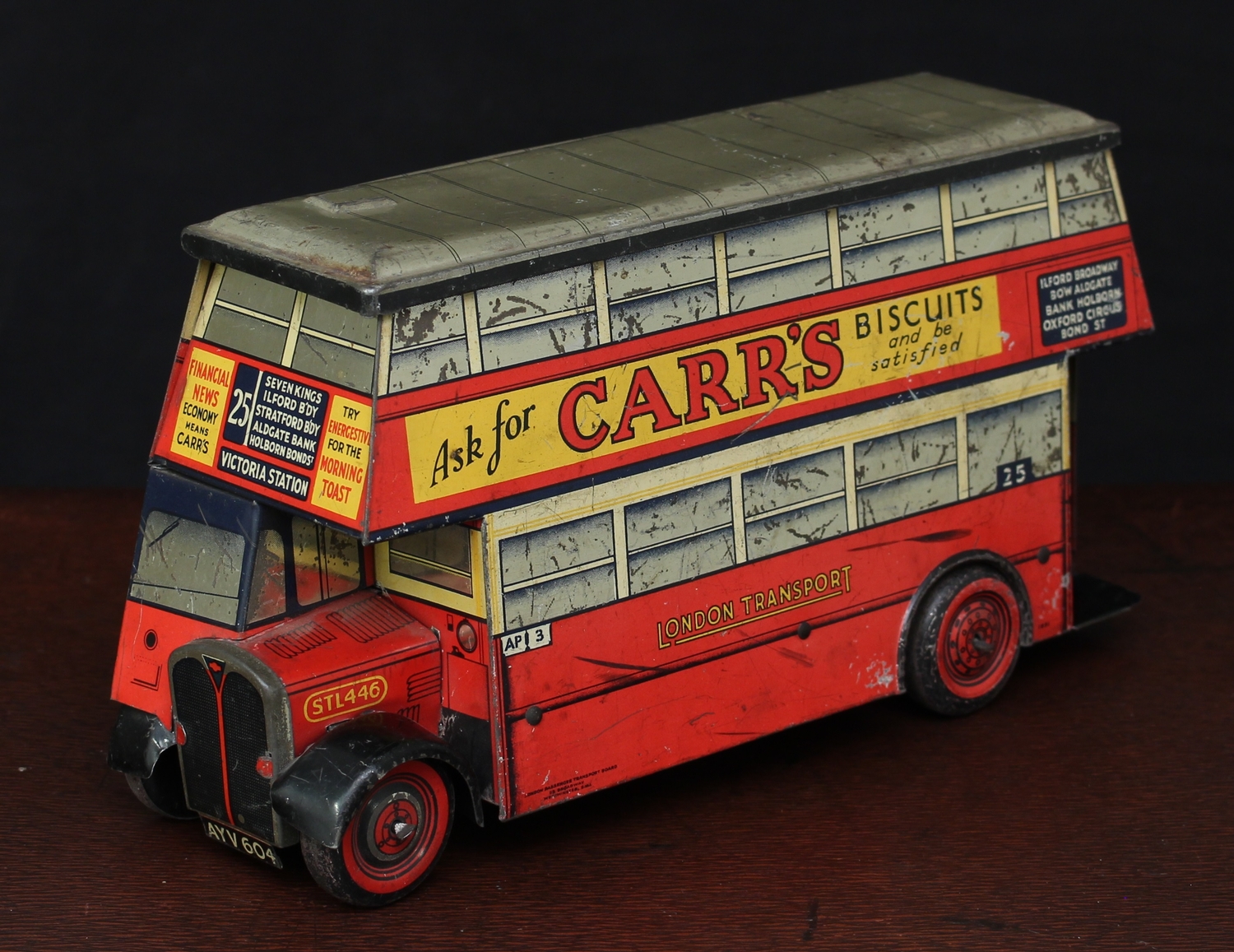 Advertising, Biscuits/Confection - A Chad Valley Carr's Biscuits tinplate novelty biscuit tin in the form of a double decker bus, lithographed in red and yellow with various advertising signs to sides, grey detachable roof, registration number 'AYV604', 26cm long