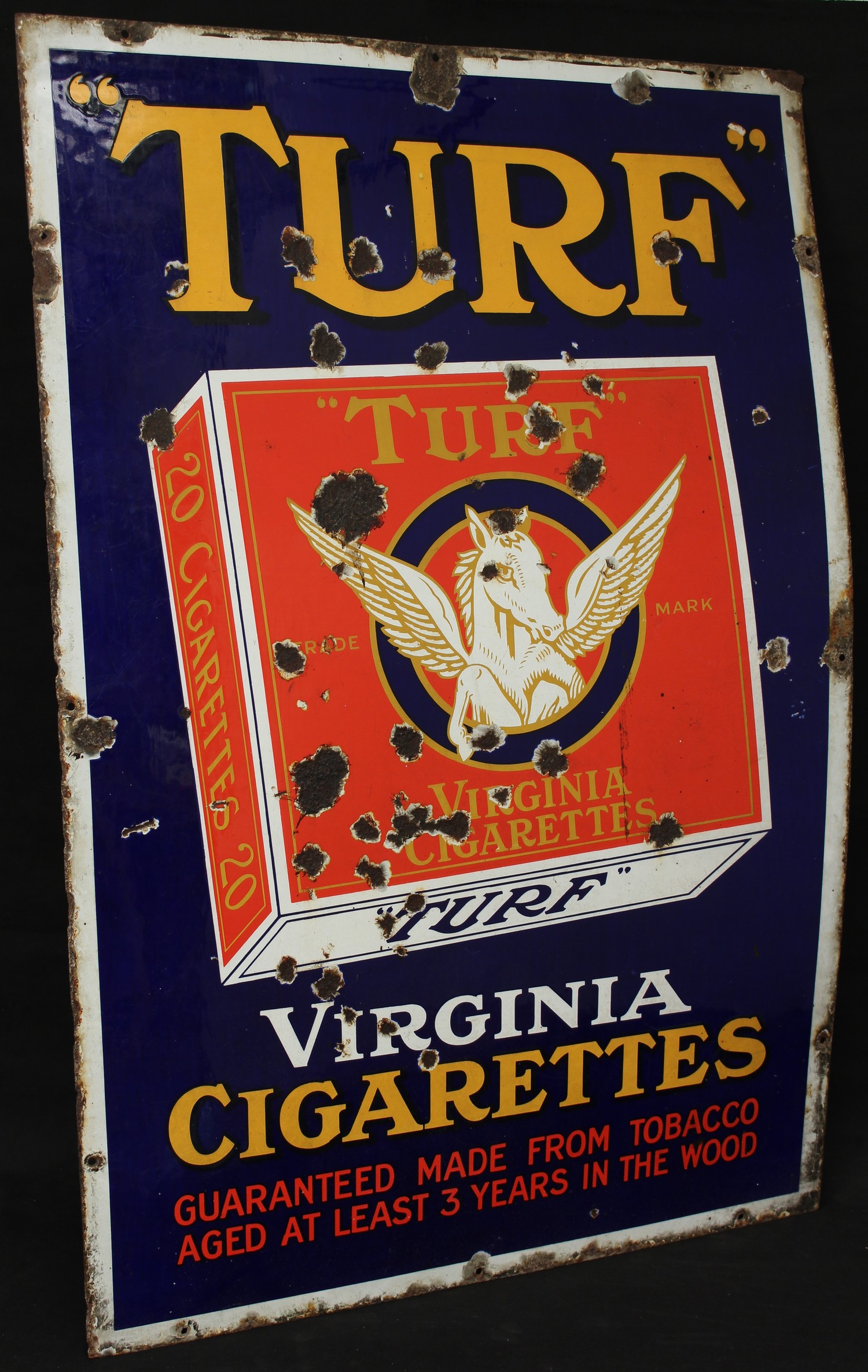 Advertising, Tobacciana and Smoking Interest - a single sided rectangular shaped pictorial enamel advertising sign, illustrated with a packet of 20 "Turf" cigarettes on a cobalt blue background, "TURF, VIRGINIA CIGARETTES, GUARANTEED MADE FROM TOBACCO AGED AT LEAST 3 YEARS IN THE WOOD", white border, 92cm x 61cm