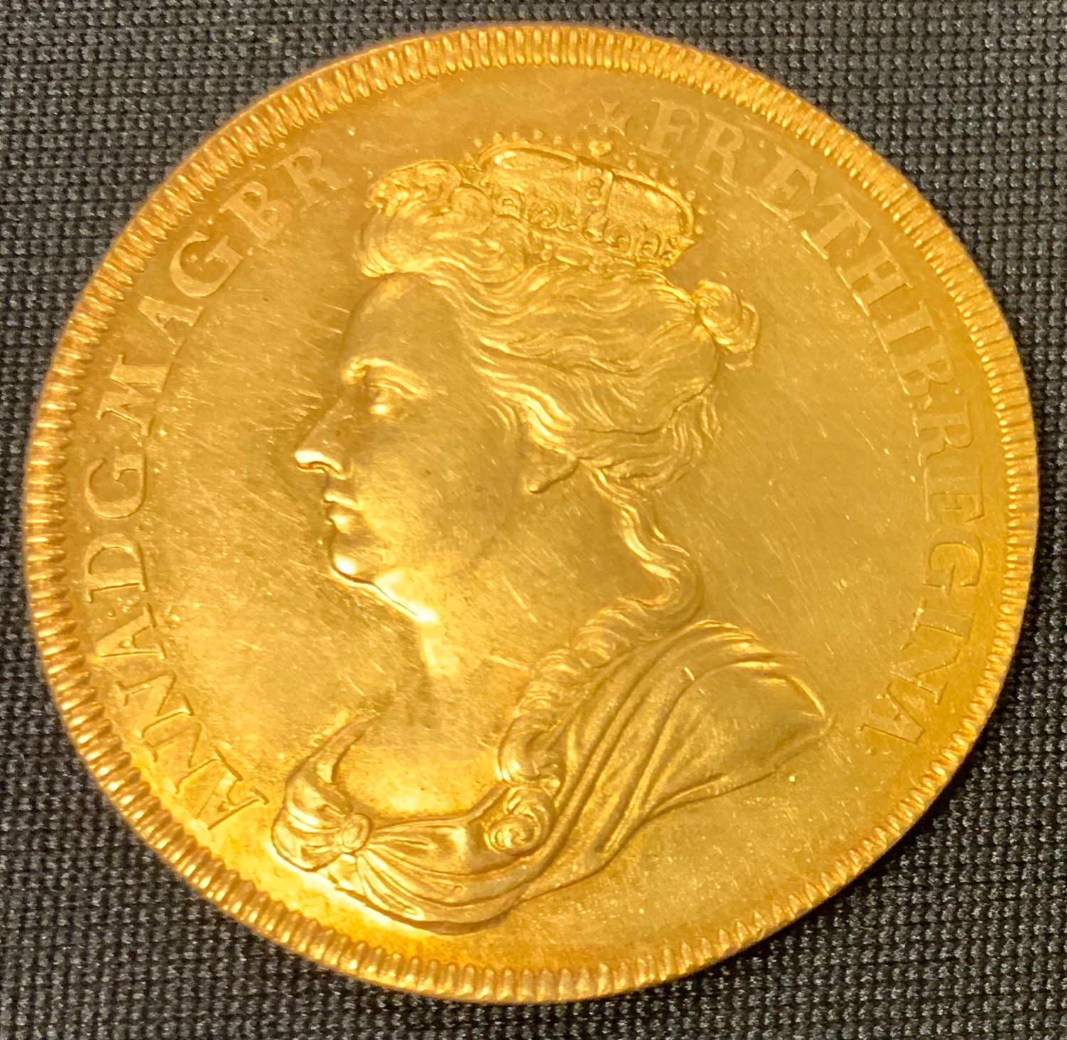 Medallion, GB, Queen Anne, 1702, a rare and important gold medallion, commemorating the Accession of Queen Anne 1702, the obverse with crowned & draped head, the reverse with a central heart, within branches of oak, entwined through a crown above, within the words ‘Entirely English’ taken from her fist speech to Parliament in which she proclaimed “I know mine own Heart to be entirely English”, on a pedestal cast in relief with ATAVIS REGIBVS, contemporary shagreen case, 35mm, 22.9g, [1