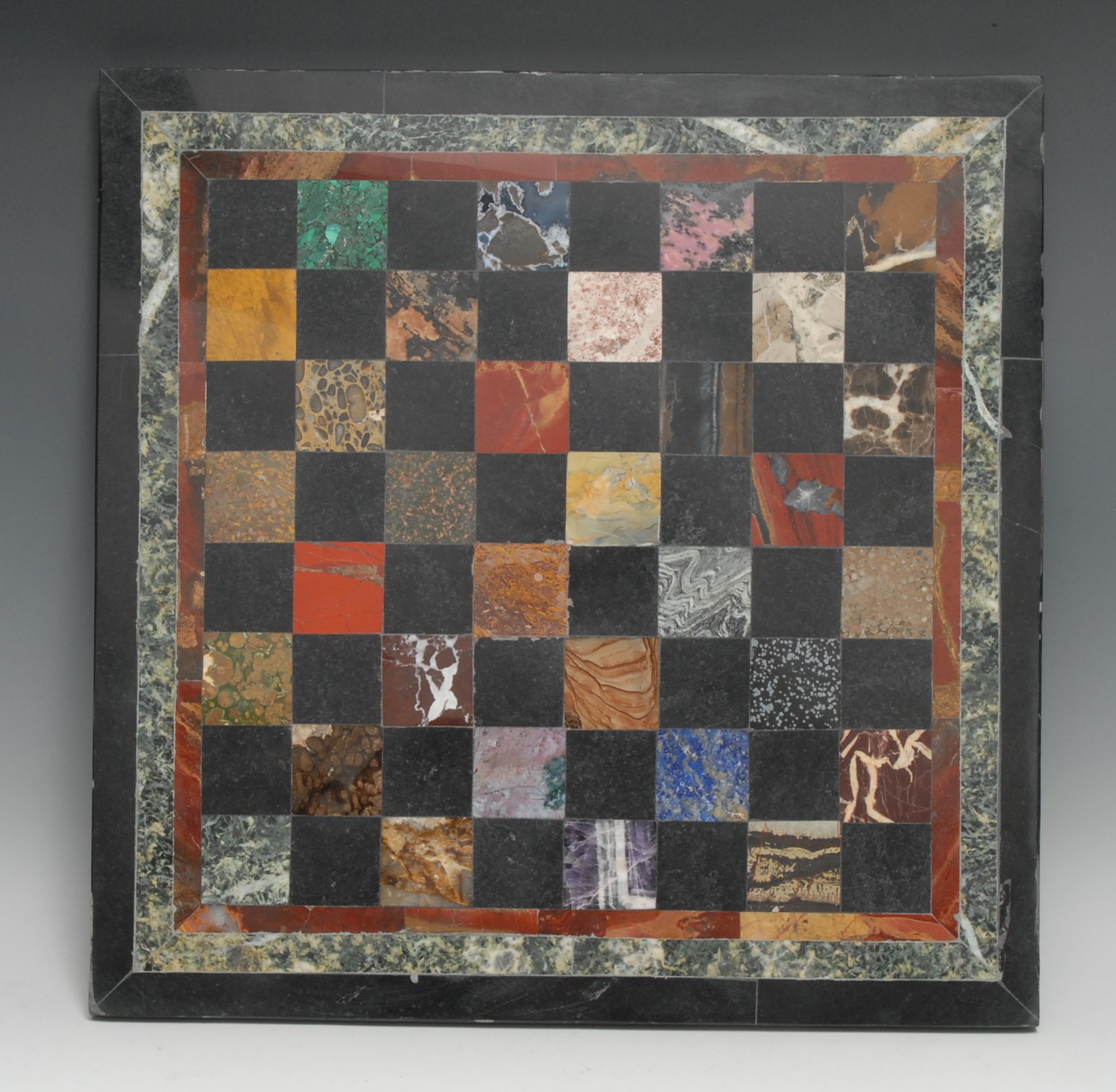 A pietra dura table top chess board, inlaid in lapis lazuli, malachite, amethyst quartz, agate and other specimen stones, 43cm square