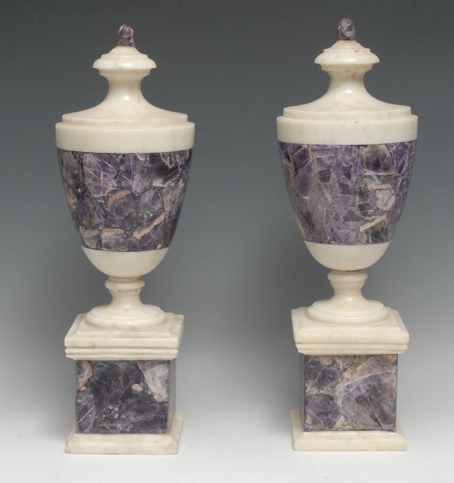 A pair of Neo-Classical design white marble and amethyst quartz mantel or table urns, square bases, 39cm high