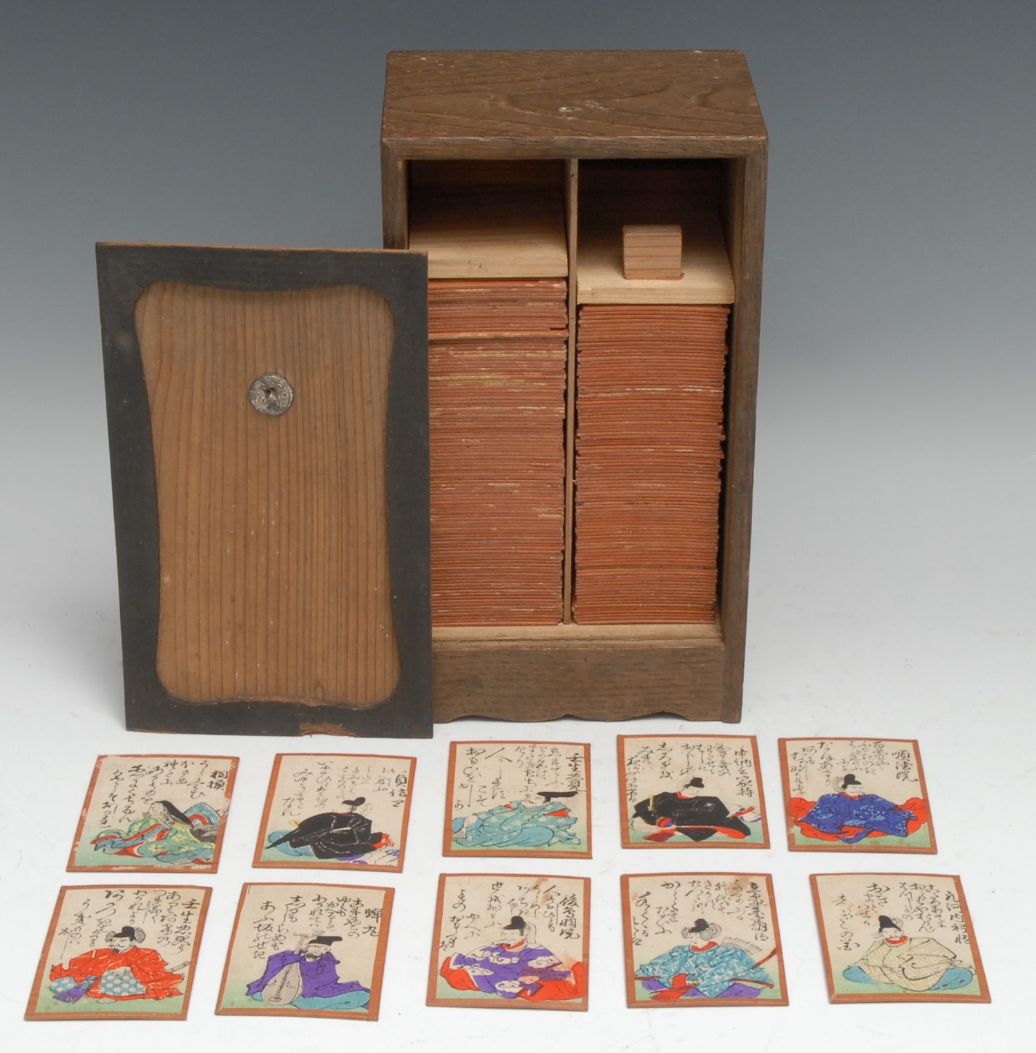 A set of Japanese Uta-garuta playing cards, composed of the Hyakunin Isshu of the Hundred Poets, each painted in watercolour and calligraphy, the cabinet 22cm high overall