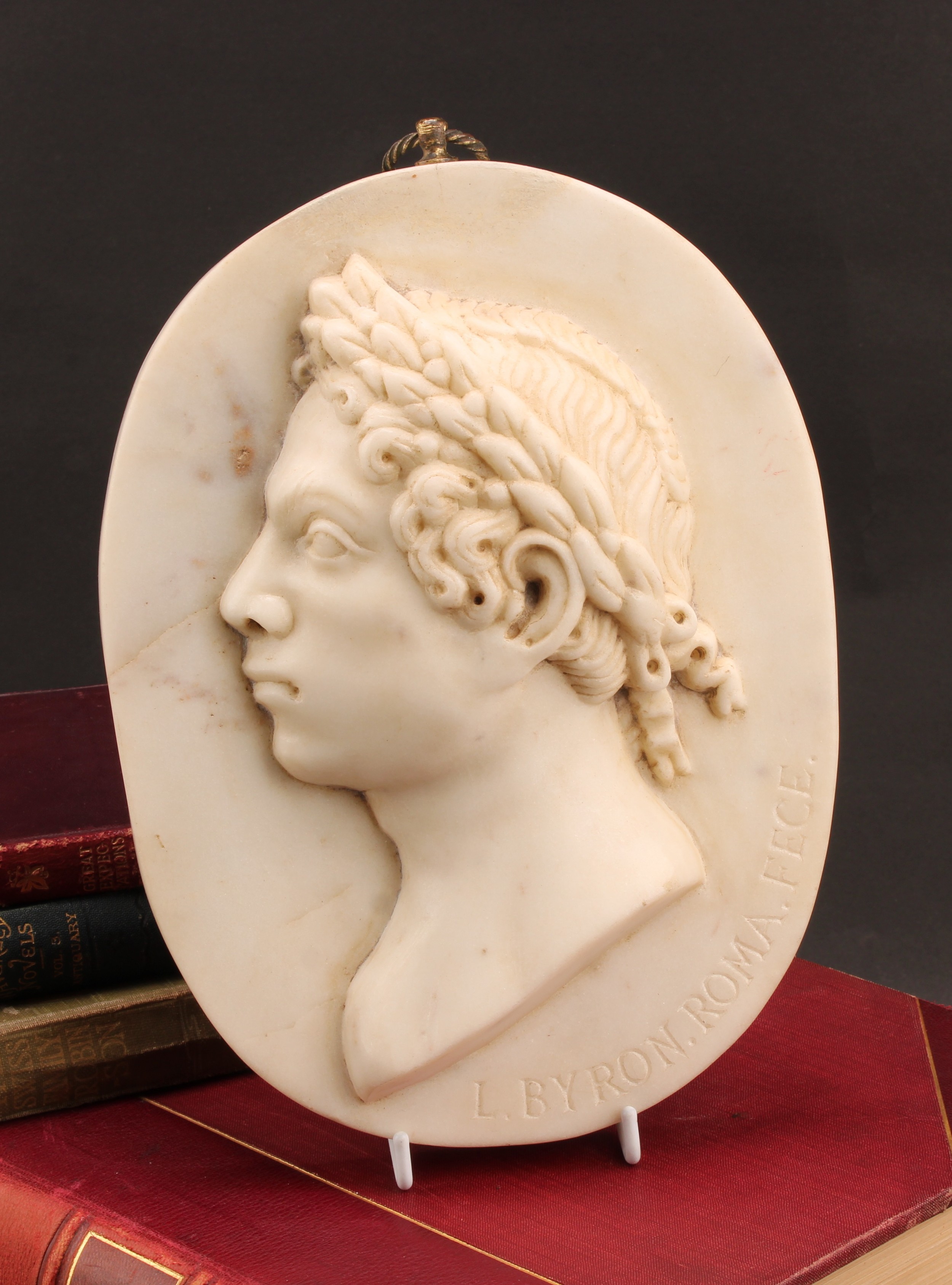 Byronmania and The Cult of Byron - a 19th century marble oval bas relief portrait plaque, depicting George Gordon Byron, 6th Baron Byron (1788 - 1824), bust length, dressed as a Roman, inscribed L Byron. Roma. Fece, 25cm x 18cm