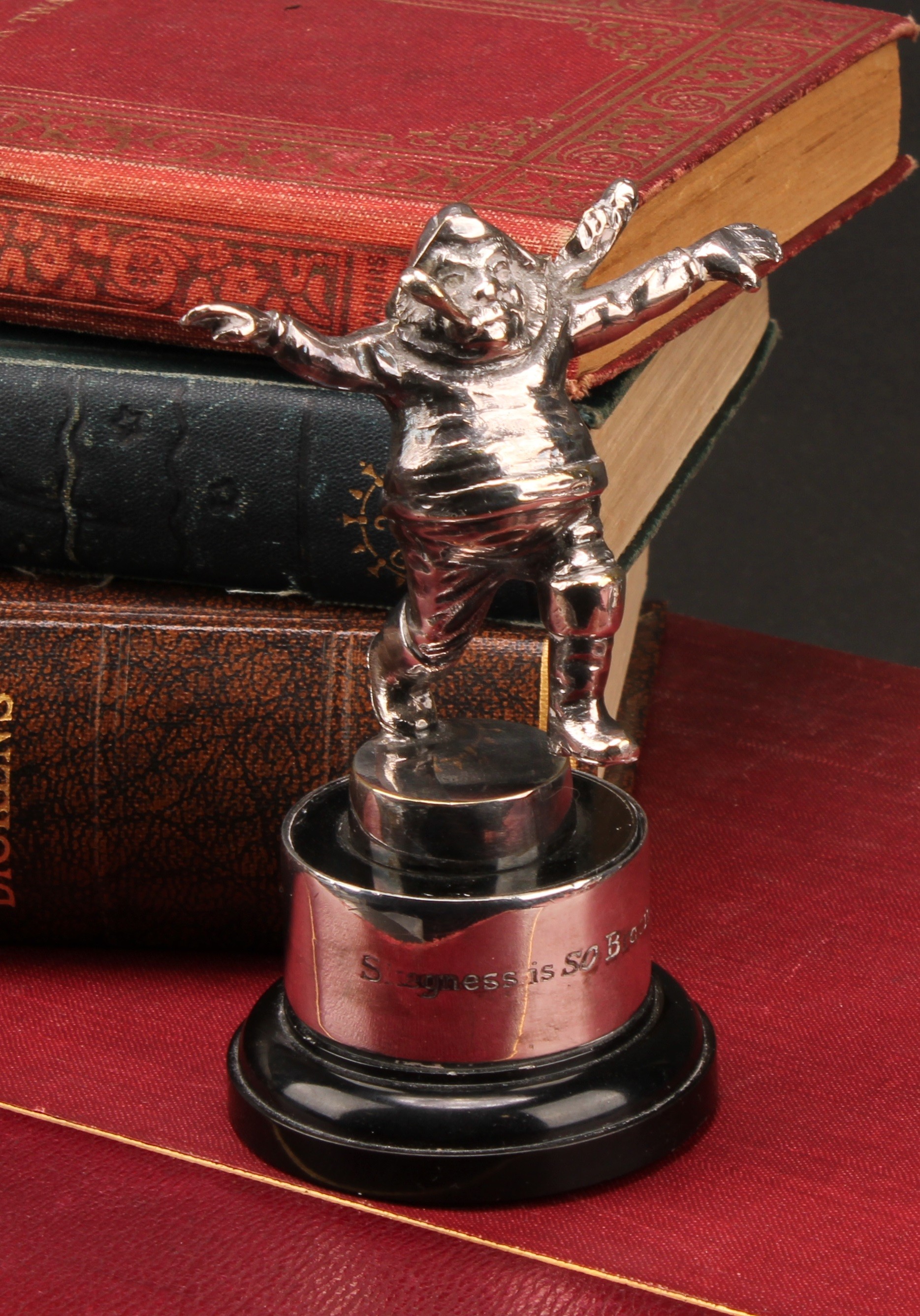A scarce advertising Car Mascot, in the style of John Hassall, depicting his famous ' Jolly Sailor' character, stamped 'Skegness is SO Bracing' N.S.G.C USHER TROPHY 1956 to plinth collar, as featured on 1920s period holiday advertisements and posters for the town, 11cm high overall