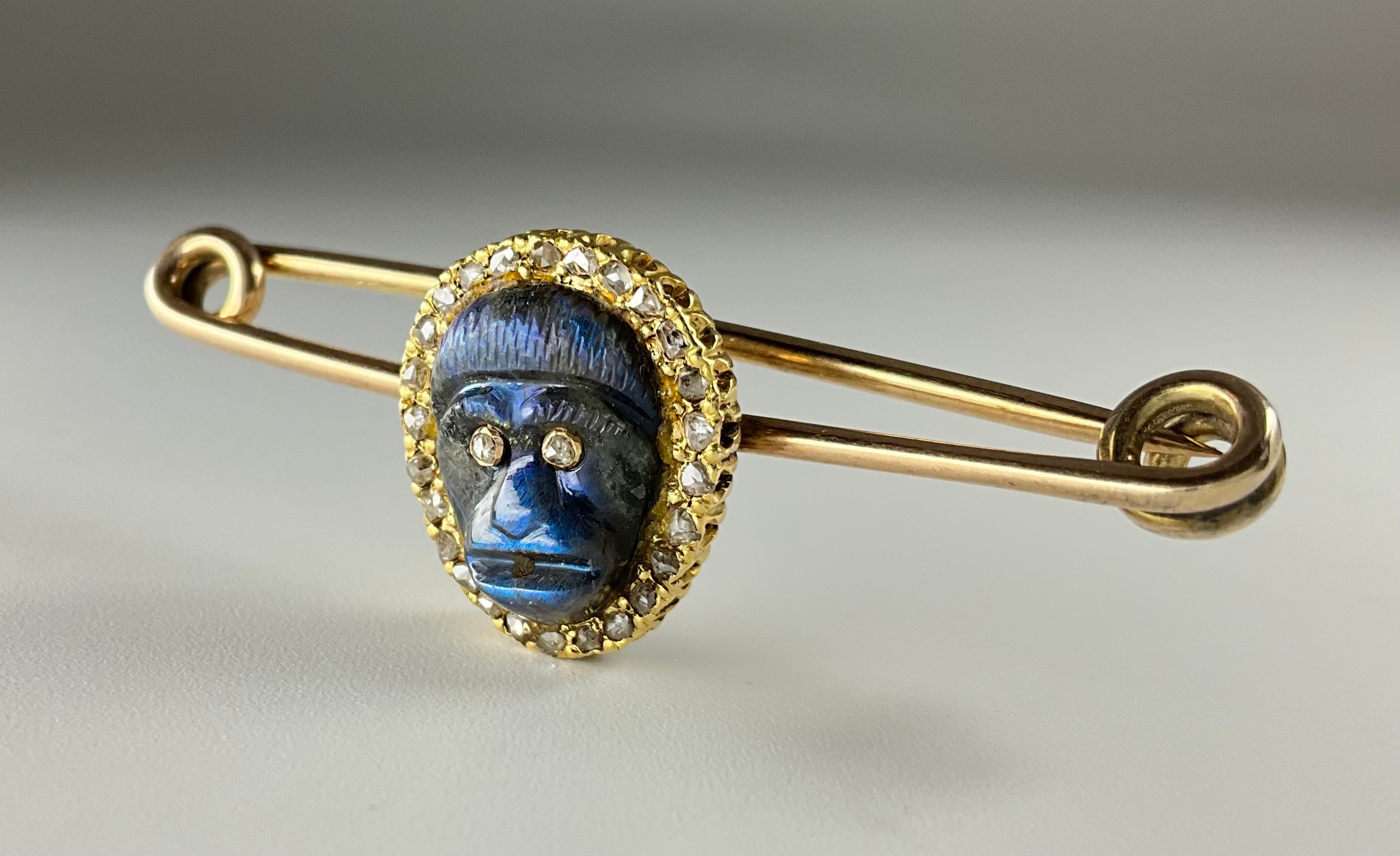 A Victorian yellow and rose gold carved labradorite and diamond monkey mask brooch