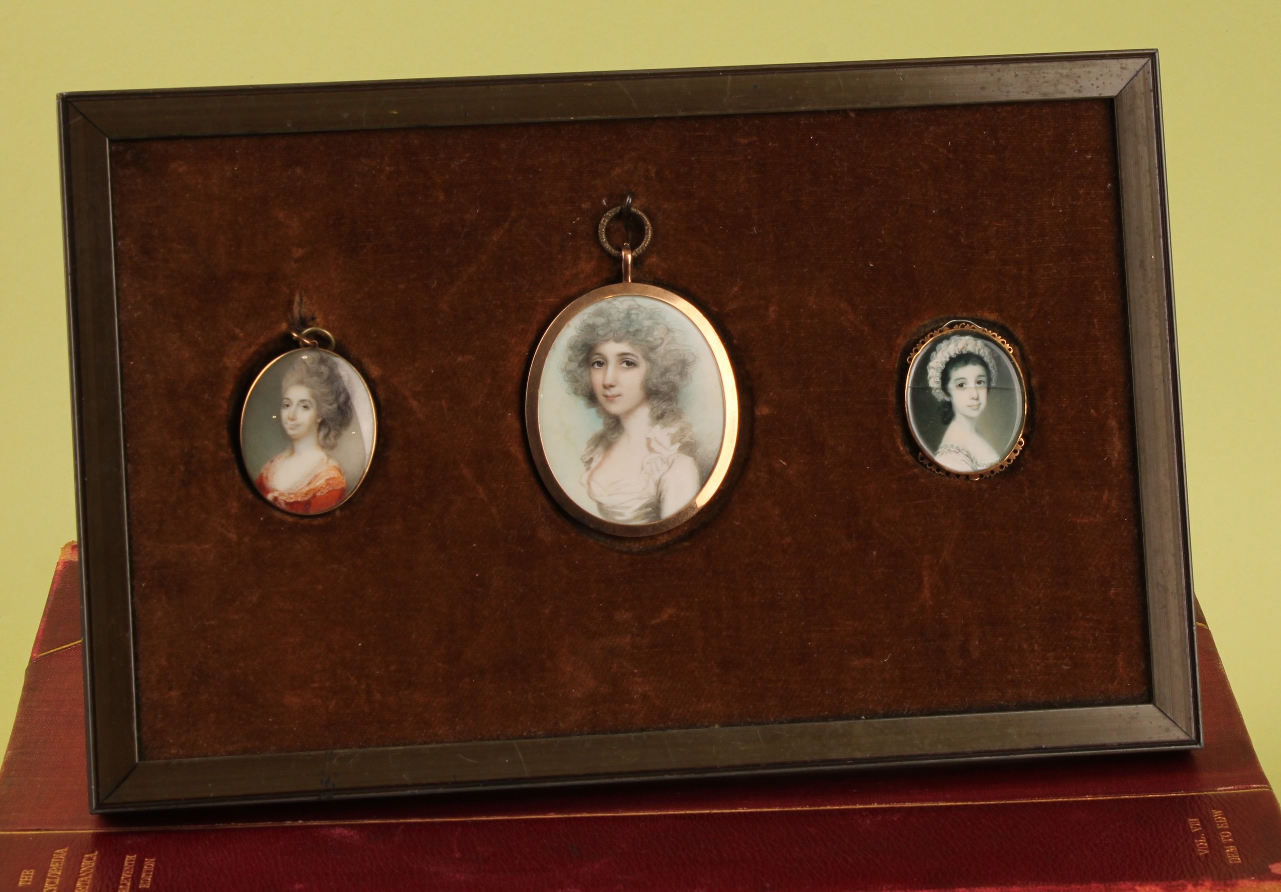 English School (18th century), a suite of three brass mounted portrait miniatures, Richard Cosway RA (1742-1821) attributed, Louisa, Lady Blake wife of Sir James Blake, watercolour on ivory, 5.5cm x 4.5cm; others similar, Julia Portius and young girl, mounted for display, easel frame  Ivory Submission Reference UA5GWDTQ Ivory Submission Reference MUW4UDN6 Ivory Submission Reference  JUM81MLQ