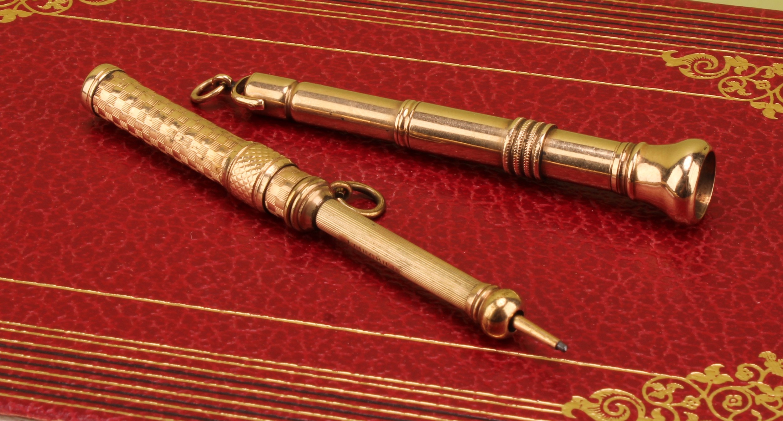 A George VI 9ct gold cigar piercer, 8cm long to suspension loop, 10.9g, Chester 1931; a rolled gold retractable pencil (2)