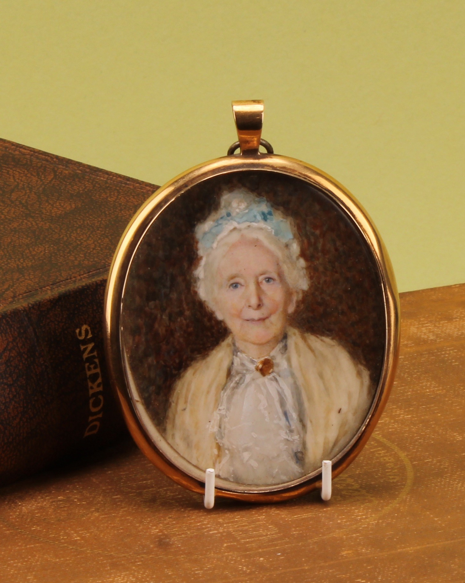 English School (19th/20th century), an oval portrait miniature mourning pendant, of an old lady of the Blake family of Bury St Edmunds (Suffolk), watercolour on ivory, 7.5cm x 6cm, the verso with lock of hair  Ivory Submission Reference E59FCYFG