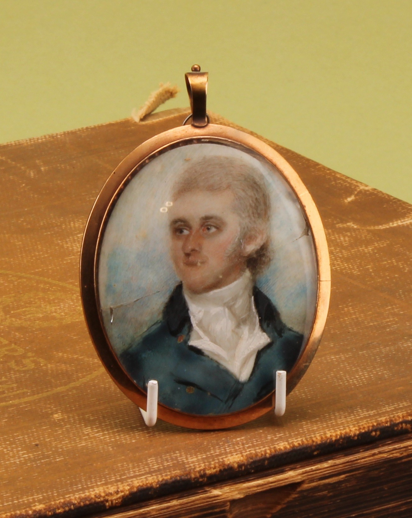 English School (19th century), an oval portrait miniature mourning pendant, of a gentleman of the Blake family of Bury St Edmunds (Suffolk), watercolour on ivory, 5.5cm x 4.5cm, lock of hair to verso  Provenance: inherited by the vendor by direct descent.  Ivory Submission Reference TNSZLMLF