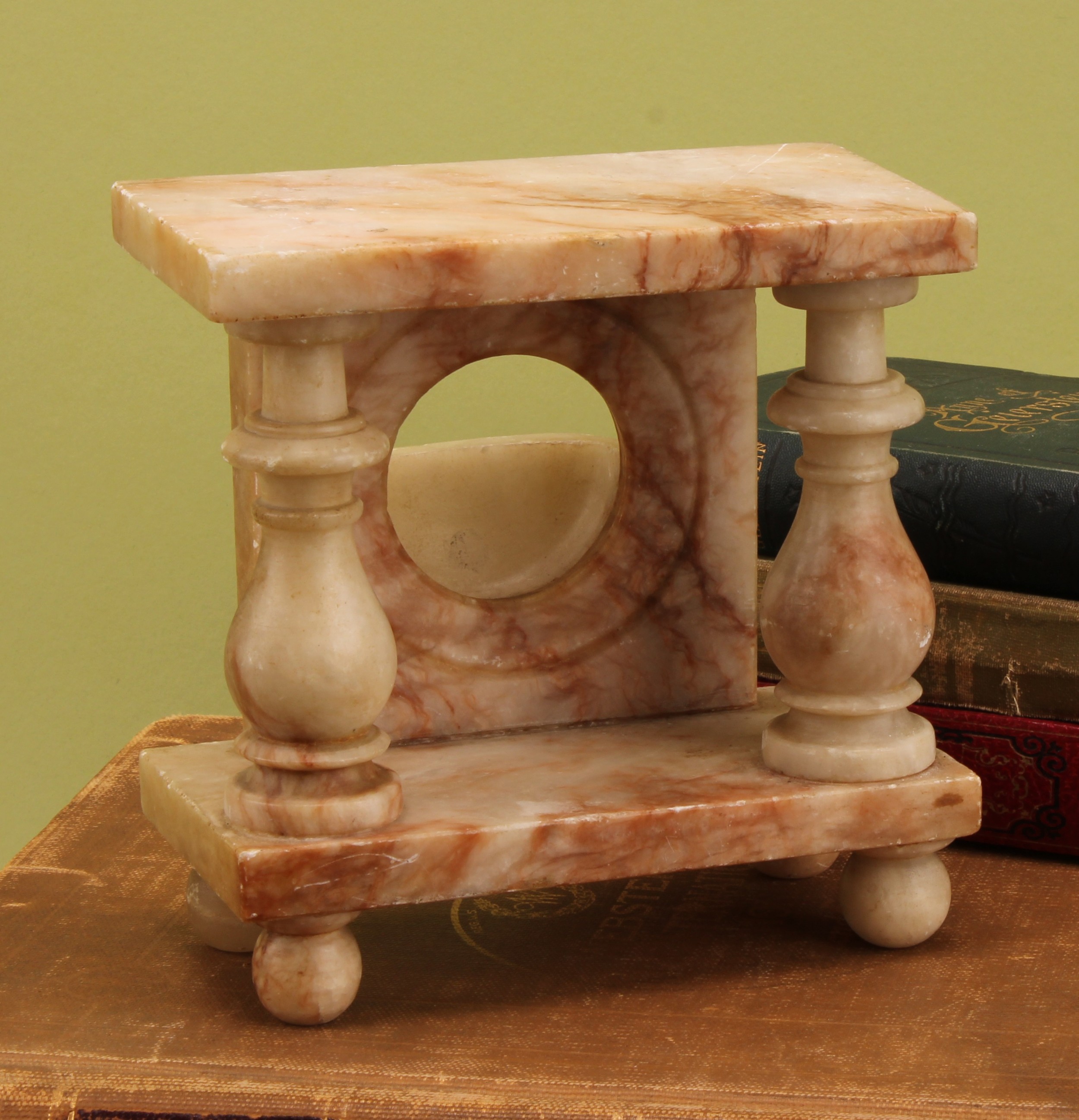 A 19th century Derbyshire alabaster portico pocket watch stand, turned pillars, ovoid feet, 15cm high, c.1860
