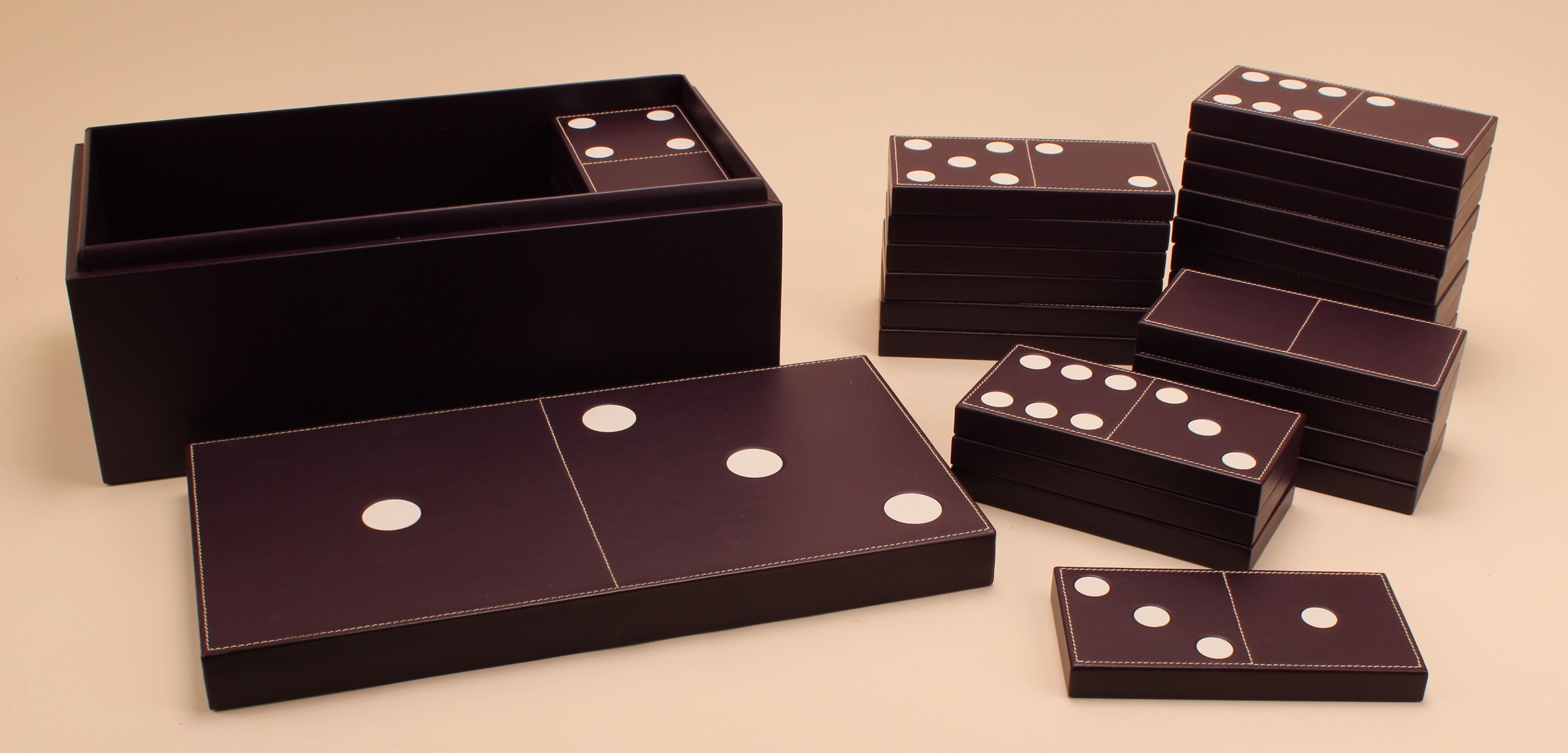 Asprey - a set of mauve leather carpet dominoes, the box 35cm wide, velvet outer cover