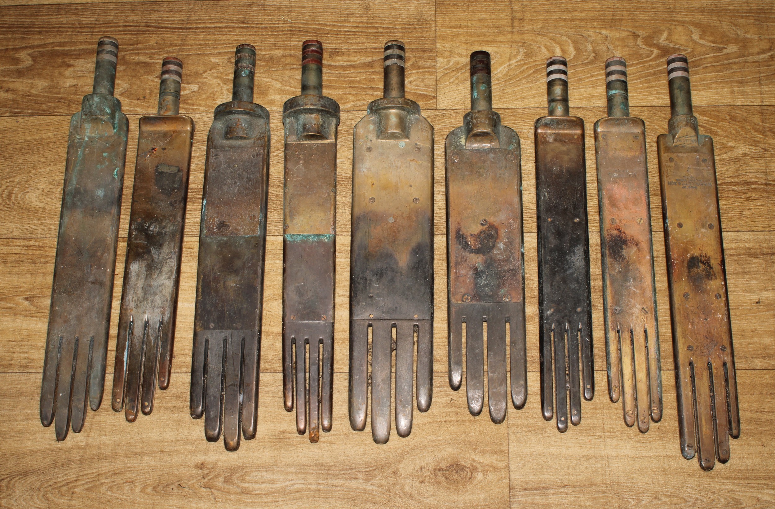 Industrial Salvage - a suite of nine early 20th century brass glover’s glove irons, various maker’s and sizes, one stamped MADE BY WH.HALLETT & SON HALSON WORKS YEOVIL, HALLECTRIC, 50cm long (9)