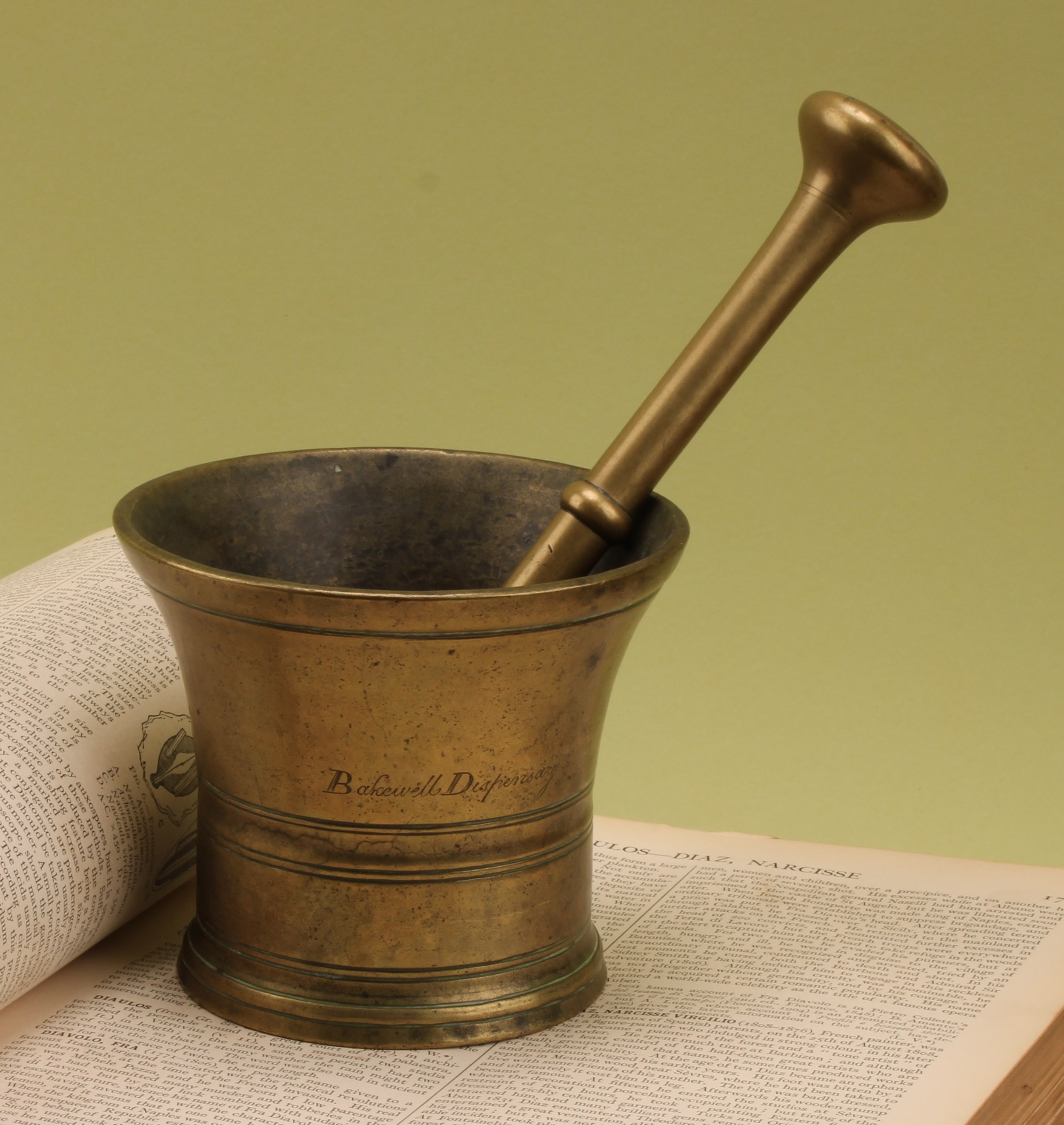 Derbyshire Apothecary Interest - a George III bronze chemist’s pestle and mortar, inscribed Bakewell Dispensary, 10.5cm high, early 19th century