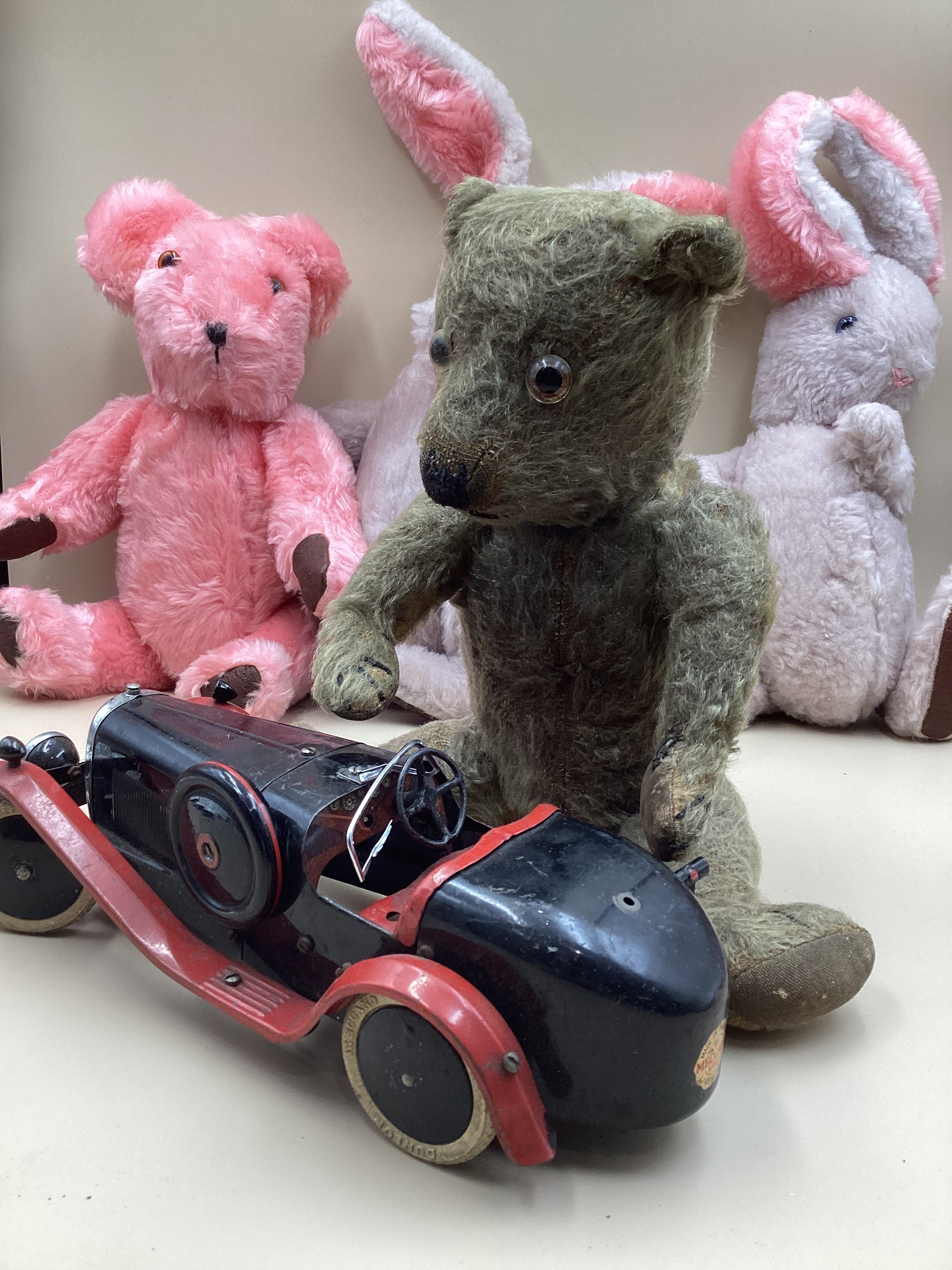 Meccano metal 1930s Racing car and driver and a selection of spare wheels etc, and  Chiltern 1930s teddy bear( no Label) and 3 1960s Plush easter bunny teddy characters- what a combination!