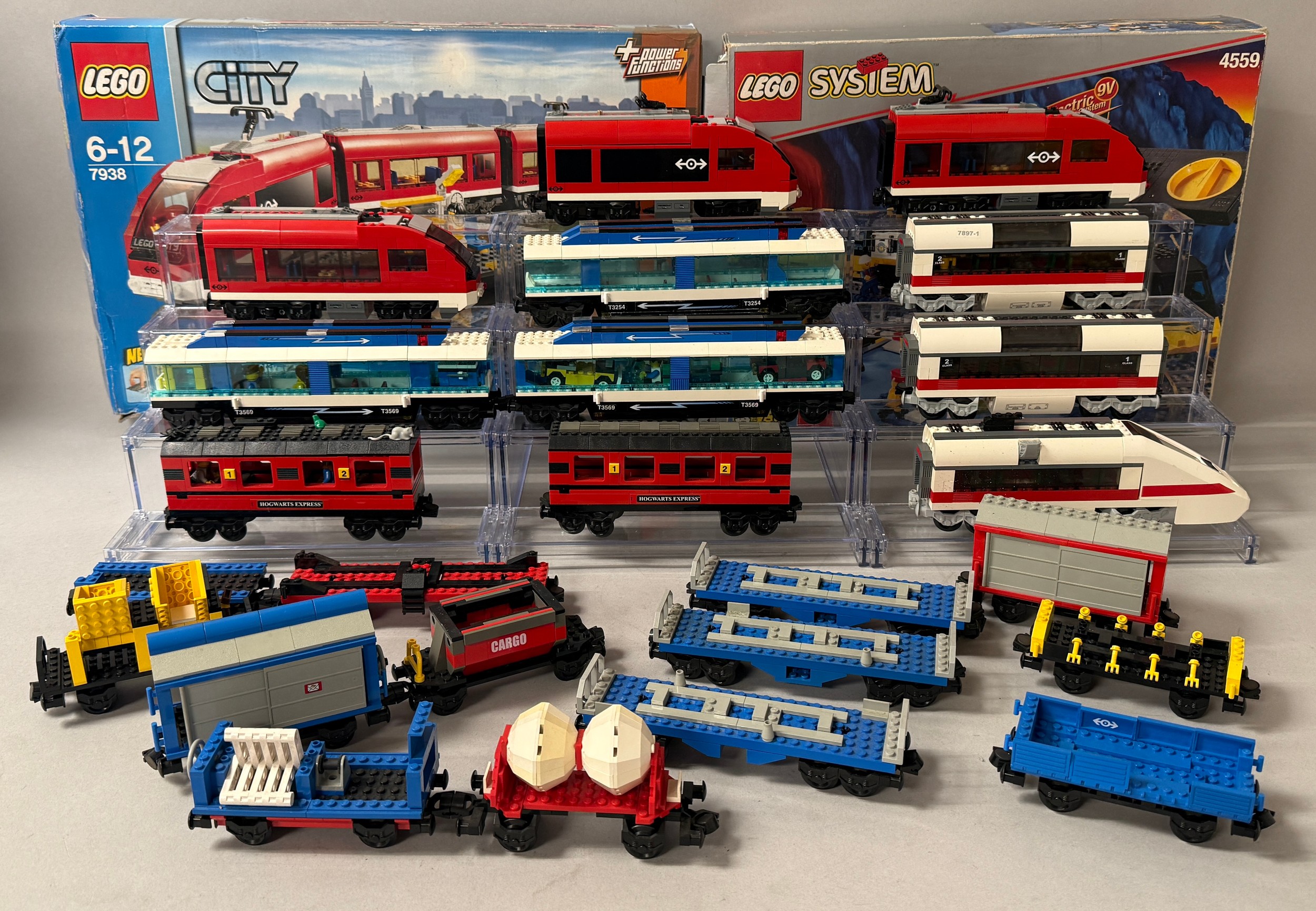 Lego - City, 7938 Passenger Trains, unboxed; 7897 Passenger train, unboxed; straight and curved train track, unboxed; System, a large quantity of straight and curved train track, 9v, unboxed; Harry Potter, 4708 Hogwarts Express carriages; unboxed; 7938 and 4559 boxes; etc (qty)  All models were constructed and remained constructed in the home and as such we do not have boxes or instruction manuals and the models are therefore sold as seen.