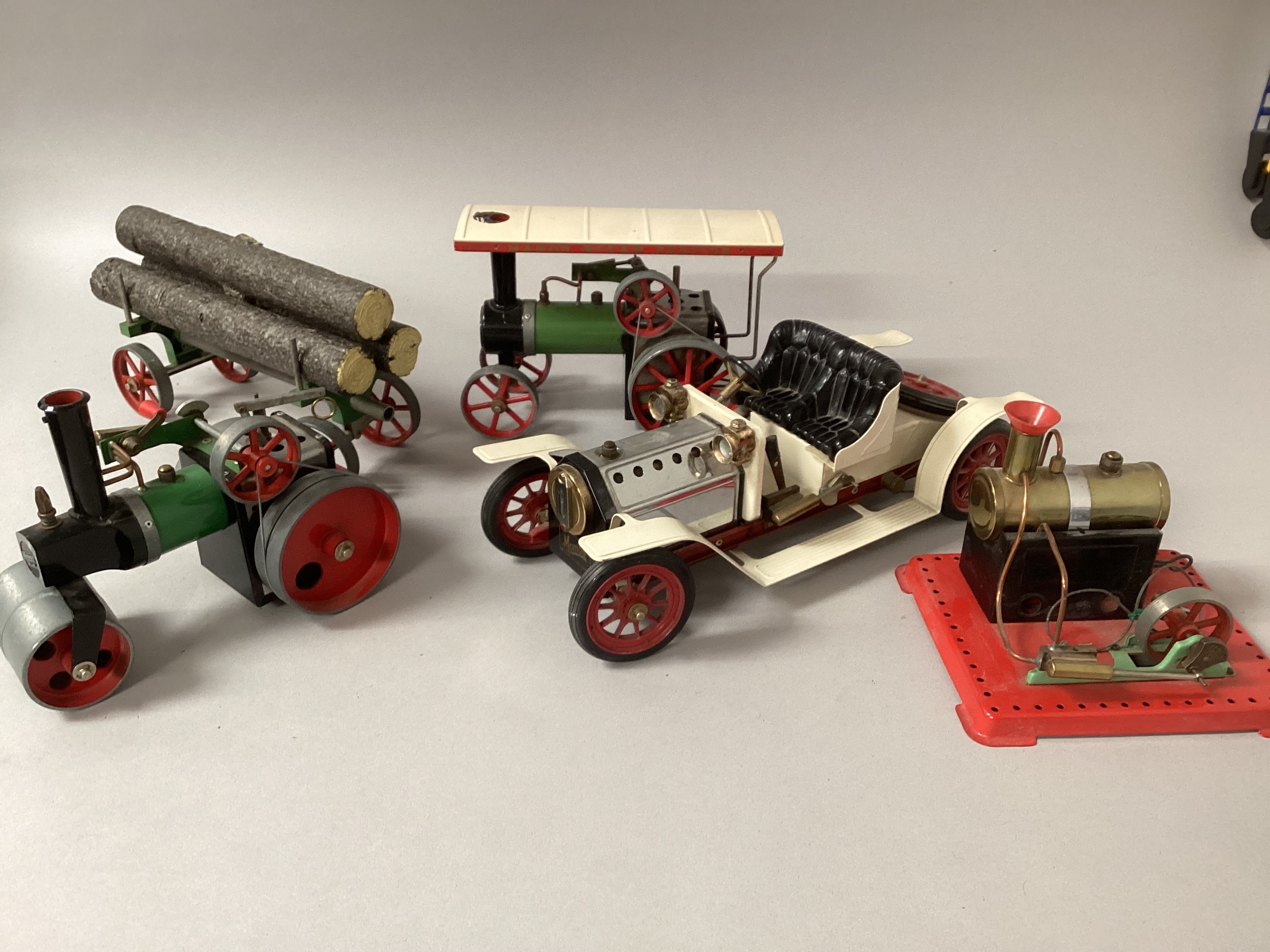 Mamod Vintage toys ; to include a steam engine, small boiler on plynth, log rack with logs and a Mamod car( seat is loose) and a Mamod steam roller unit-whole large selection