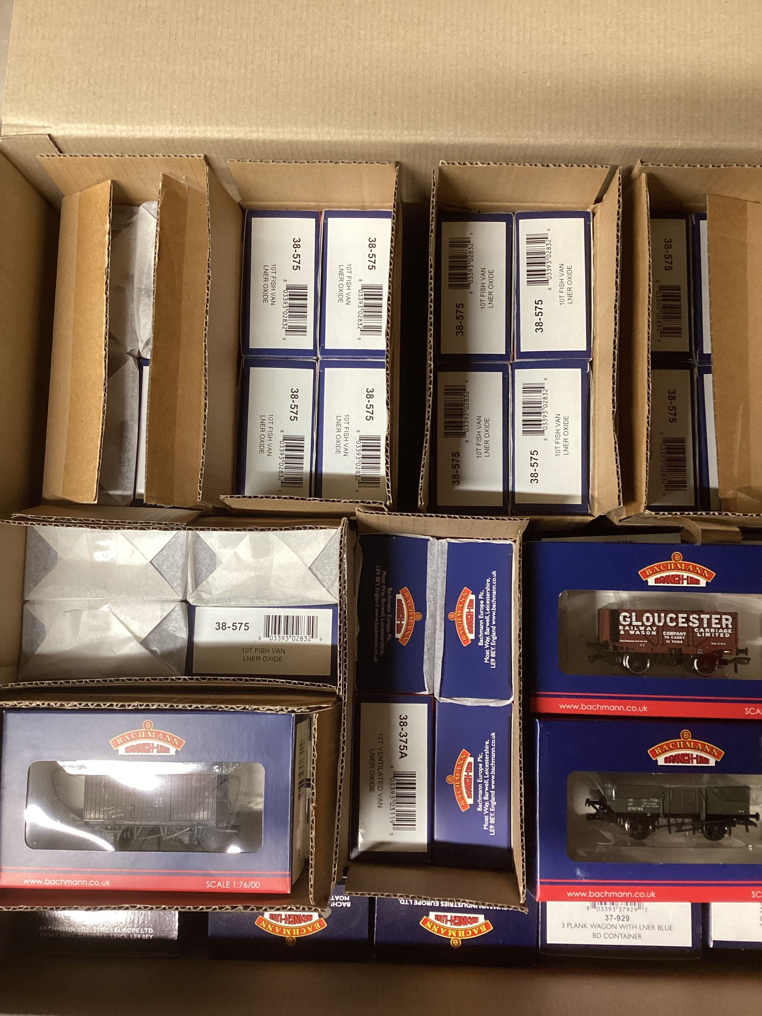Model Railway interest ; Bachmann OO gauge rolling stock - 38-575 10T Fish Van, LNER Ventilated (20), 38-375/38-375A 12T ventilated Van, LNER Oxide (11), 38-385 12T ventilated fruit van BR Bauxite (Early distressed colour), 37-800 12 Ton planked ventilated Van LMS grey (3) 37 -929, 3 plank wagon, LNER blue BD container (7) 37-2012K 7 plank wagon, Gloucester Railway Carriage & Wagon Company limited , etc all boxed (40+ old store packed stock many in trade cartons)